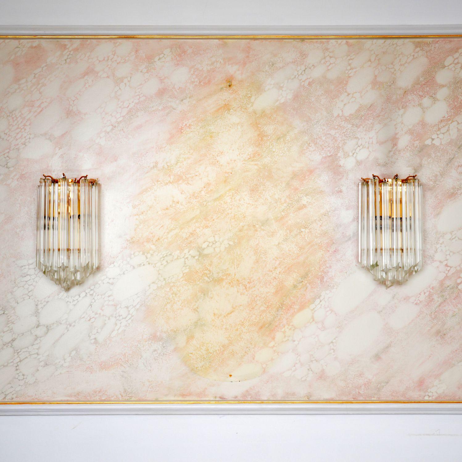 A stunning pair of original Paulo Venini wall sconce lamps in Murano glass and brass. They were made in Italy, and date from the 1970-1980s.

They are of incredible quality, with individual hand cut Murano glass drops hanging from the brass frames.