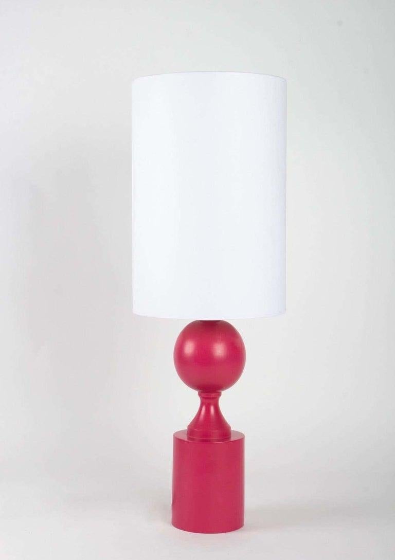 The base is in turned wood, a cylindrical base topped by a shower foot and a ball.
The color is original, red base slightly pink.
They are dressed with a cylindrical lampshade in off-white cotton redone identically.
The signature is located under
