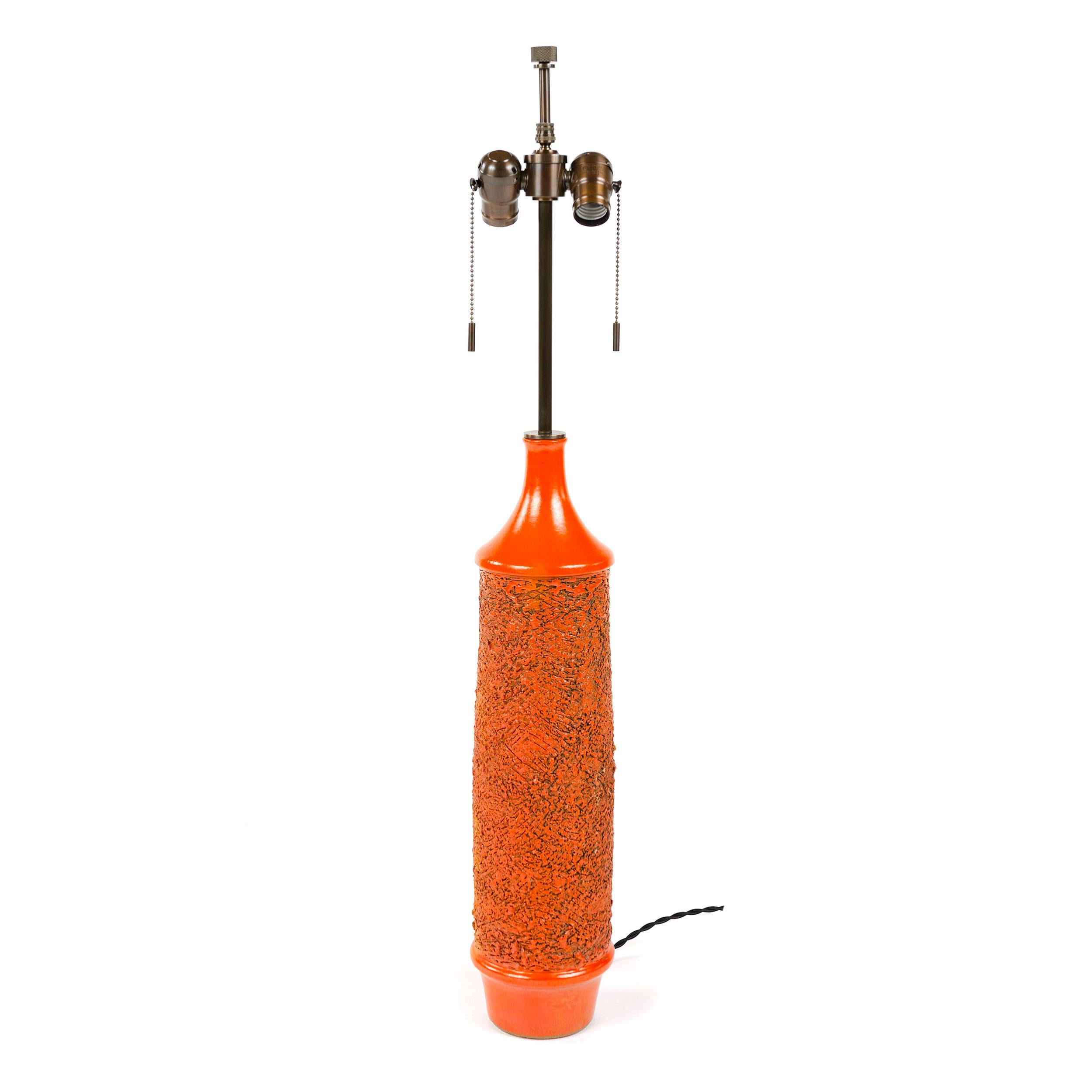 Lampe de table en céramique de forme cylindrique, tournée à la main, présentant une glaçure rouge-orange riche et brillante et un décor de sgraffites encerclant et profondément texturé, conçu en 1969 par Lee Rosen pour la série 3300. Au moment de la