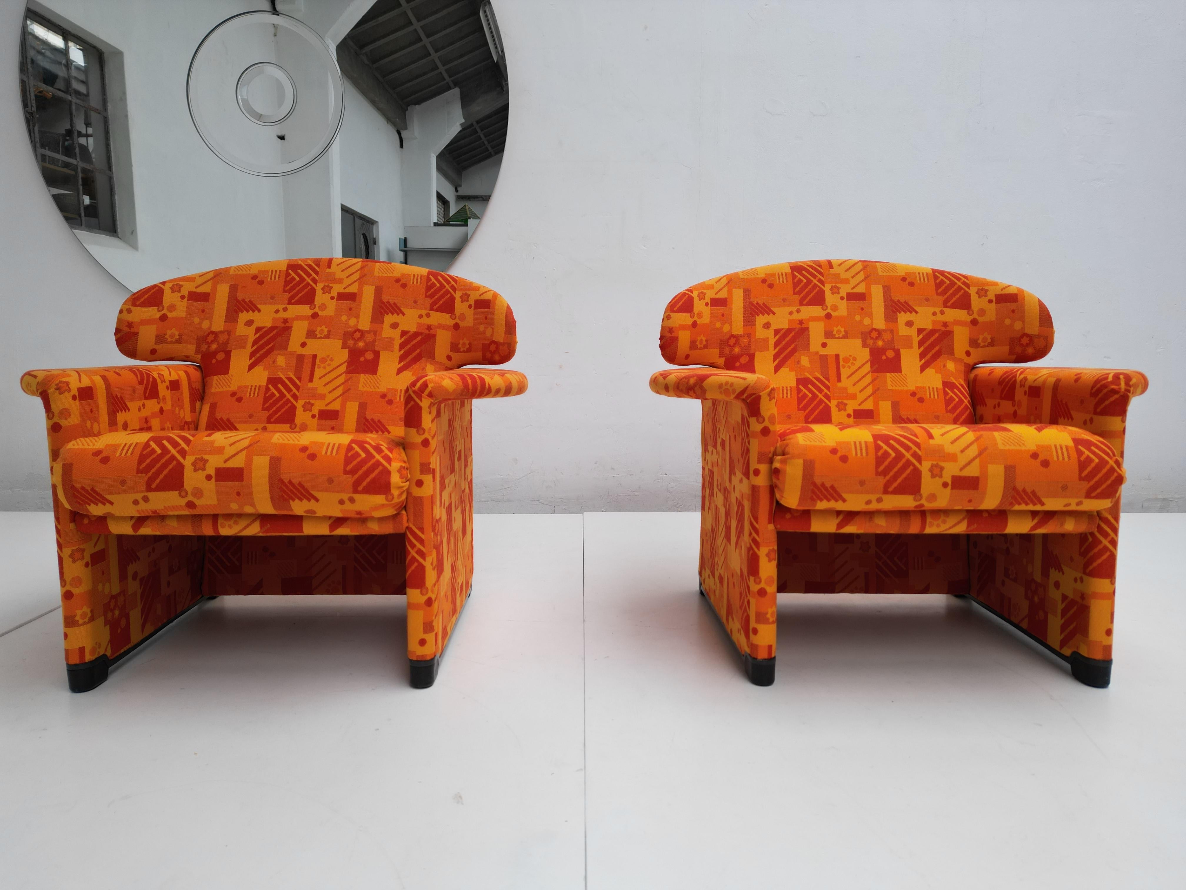 Unique & Bespoke newly upholstered pair of lounge armchairs designed by Afra & Tobia Scarpa for Spanish furniture brand Casas, C. 1970s

Reupholstered in a geometric pattern orange wool old stock 70's Wool fabric

These Lounge Chairs are a rare find
