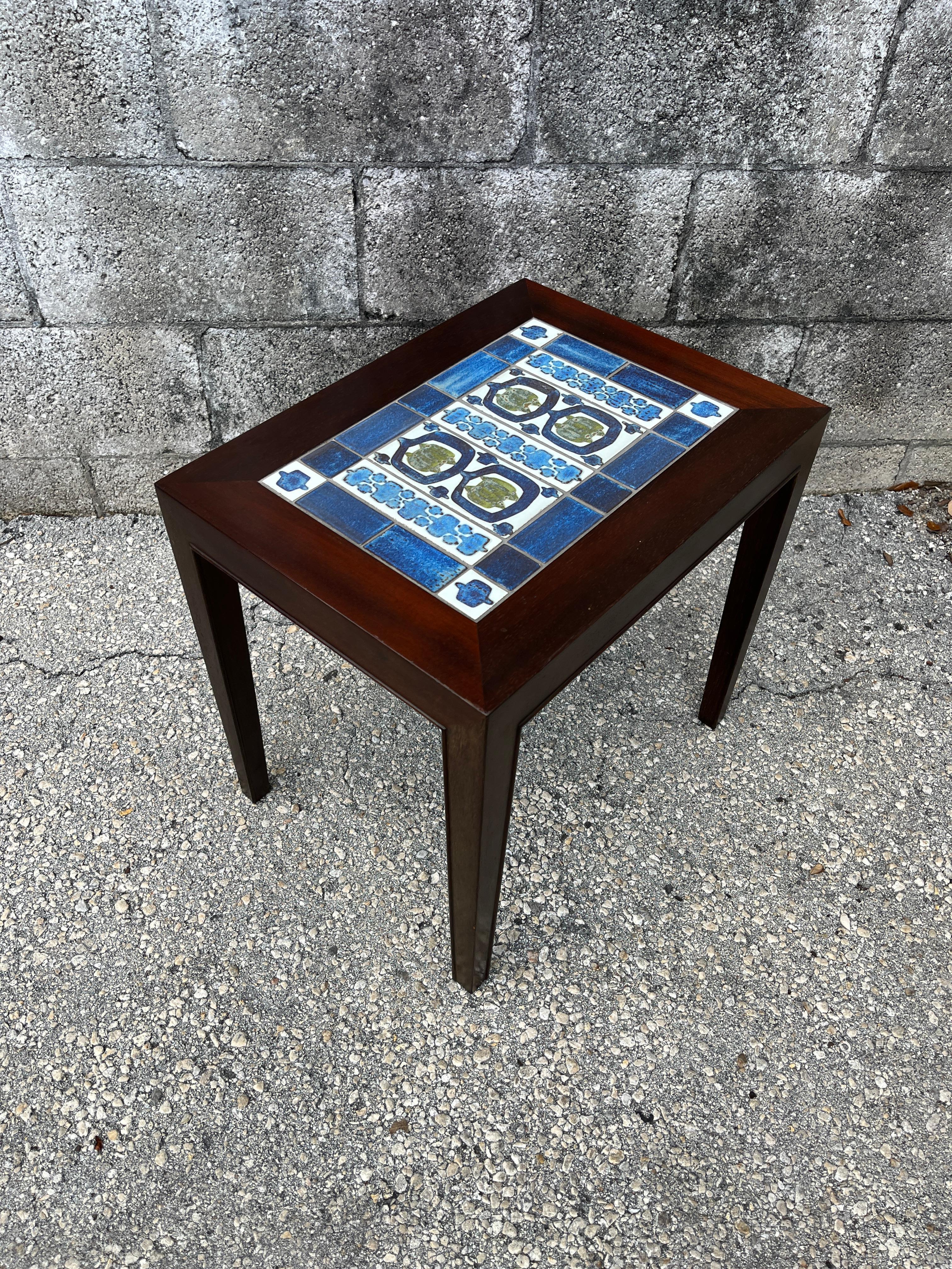 Mid-Century Danish Modern side table with tile-inlay top by Severin Hansen Jr. for Haslev Mobelsnedkeri, Denmark. Circa 1960s 
Features a quintessential Clean Lines Mid Century Scandinavian Design with tiles made by Royal Copenhagen in blue and