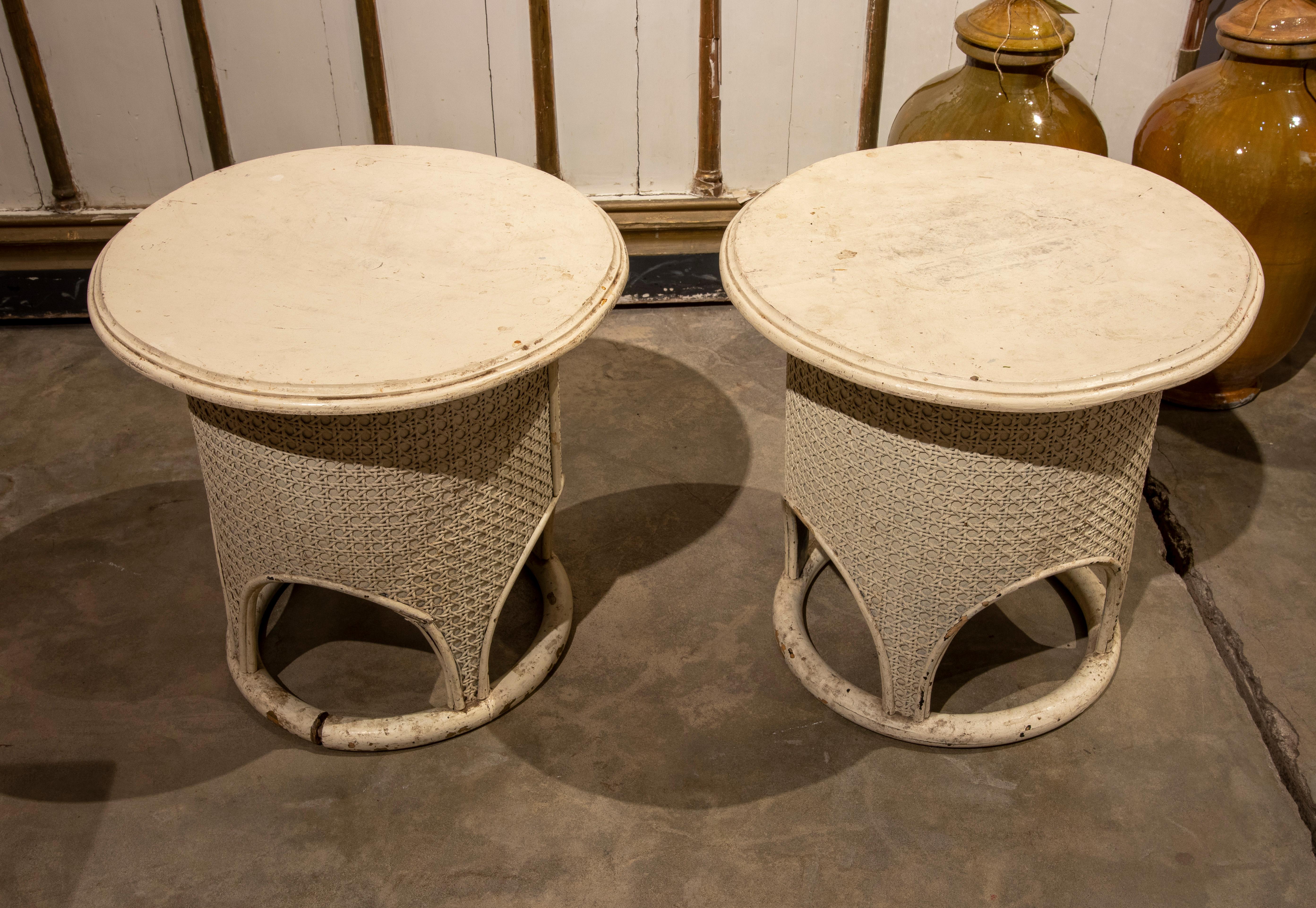 1970s pair of round wooden side tables with wicker.