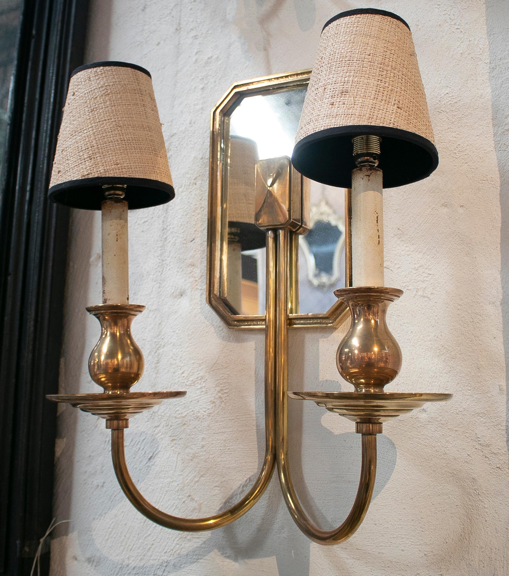 1970s pair of Spanish bronze wall lamps with shades and mirror.