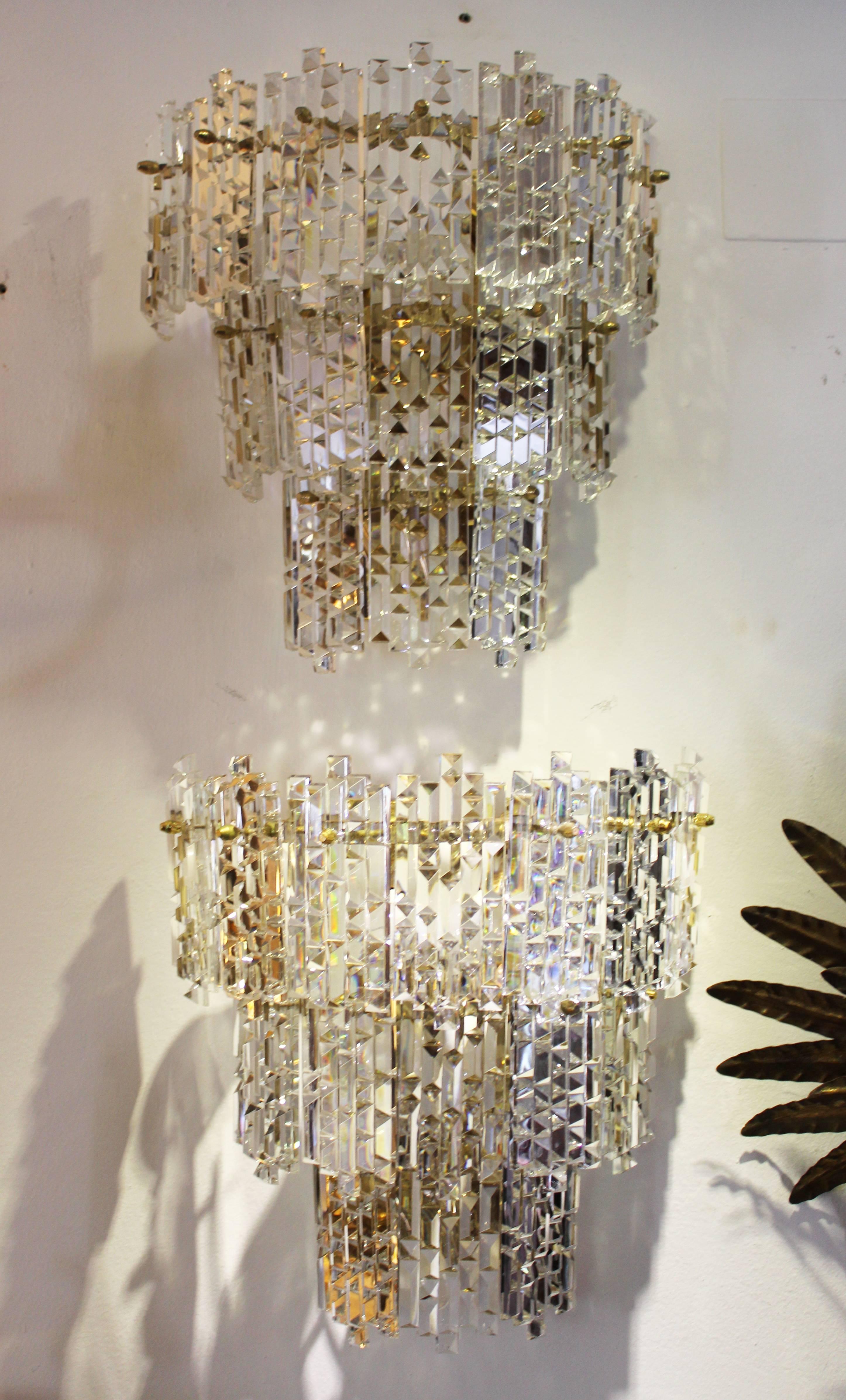 1970s pair of Spanish gilded brass wall lamps with beveled crystal.

Three pairs in stock.