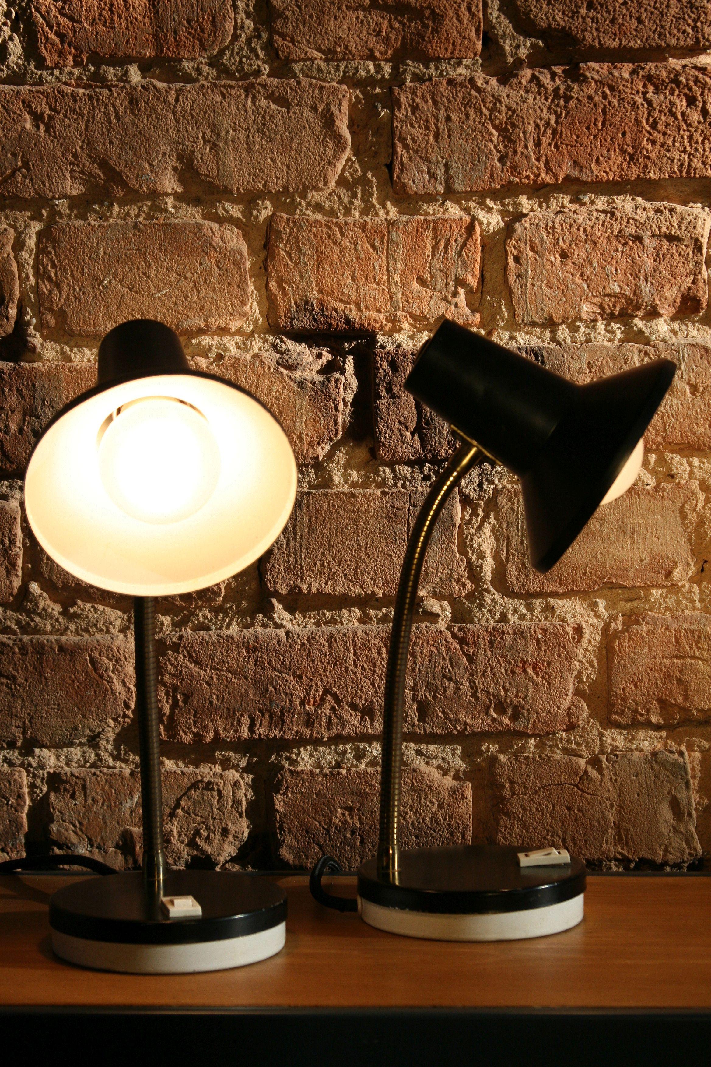 Modern design, two pieces of table lamps produced in Germany in the 1970s.

Construction:
The base and the lampshade are made of pressed steel sheet and covered with an original black and white varnish. The arm of the lamp is made of an elastic