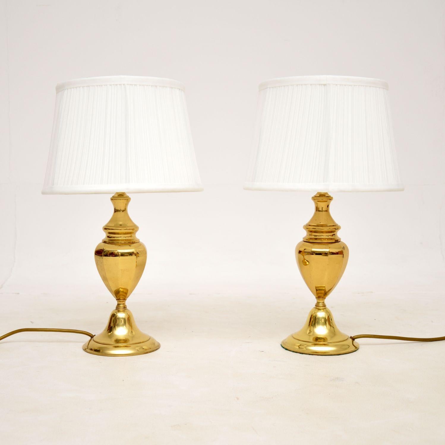 A stunning pair of vintage table lamps in solid brass. They were made in England, and date from the 1970s.

The quality is superb, the bases have a gorgeous urn shaped design. They are fairly petite yet heavy and solid for their size.

They are