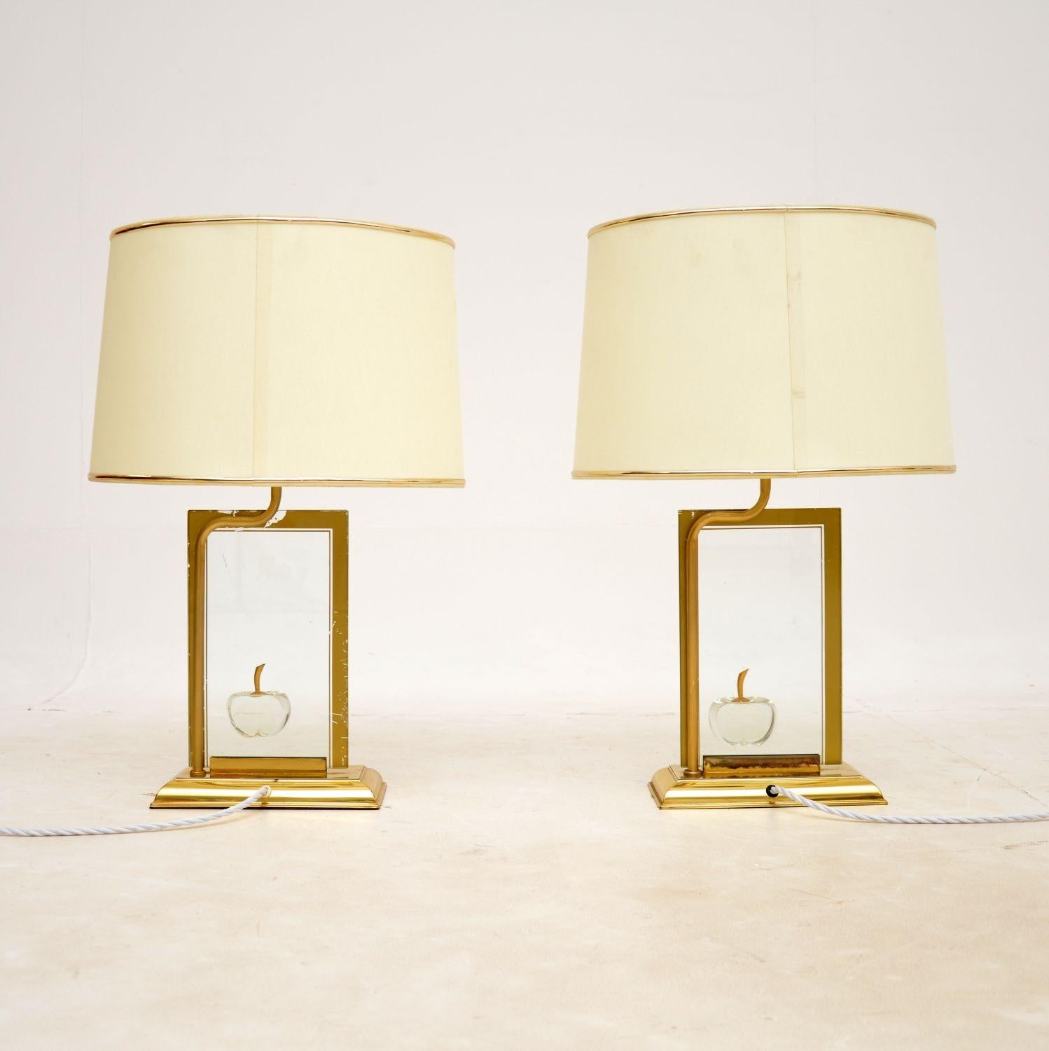 A beautiful pair of vintage French table lamps in brass and glass. They were recently imported from France, they were made in the 1970’s by Le Dauphin.

The design is gorgeous, each is made from a sheet of thick decorated glass that sits on a brass