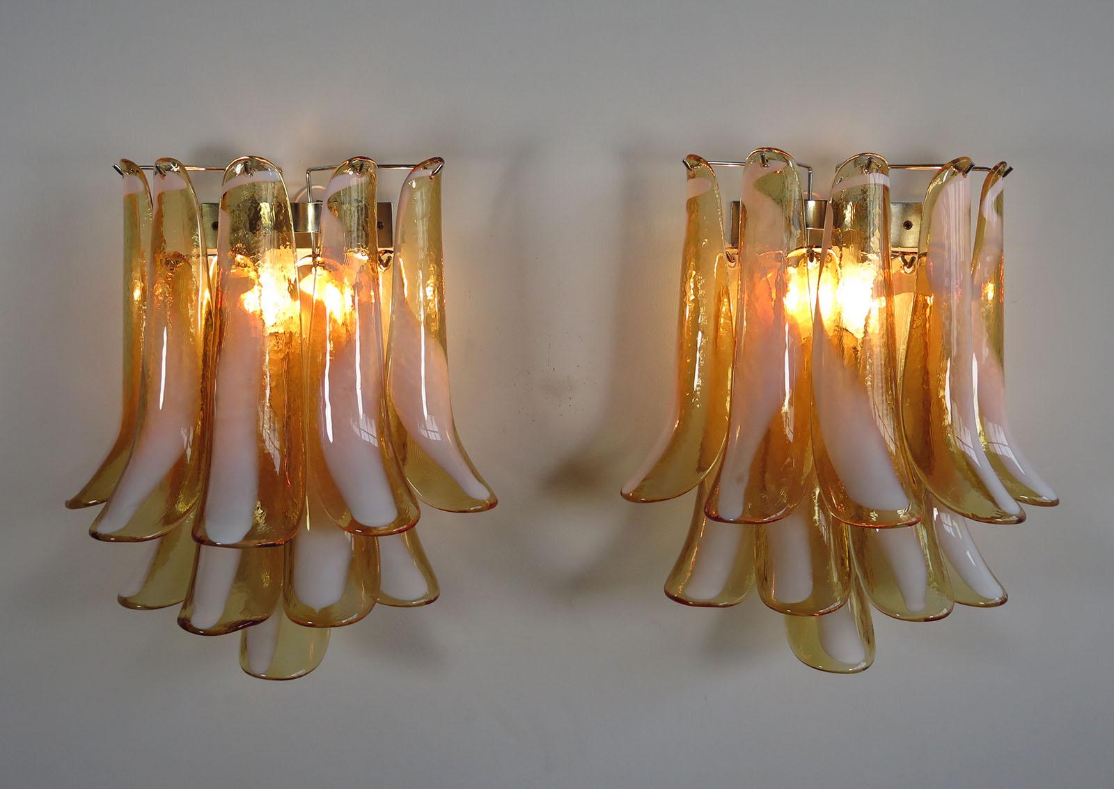 Pair of vintage Italian Murano appliques in the manner of Mazzega. Wall lights have 10 caramel lattimo glass petals (for each applique) in a chrome frame.
Period: 1970s
Dimensions: 16.50 inches (42 cm) height, 13.80 inches (35 cm) width, 7.90