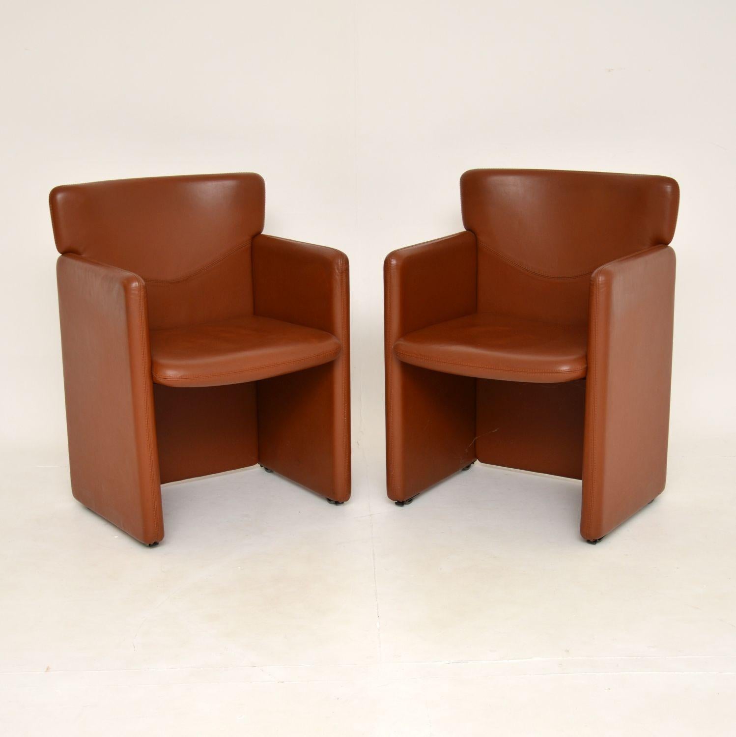A fantastic and quite unusual pair of vintage tanned leather armchairs. These were made in England, they date from around the 1970’s.

They are of quite small proportions, but are still very comfortable and supportive. The bases have wheel that