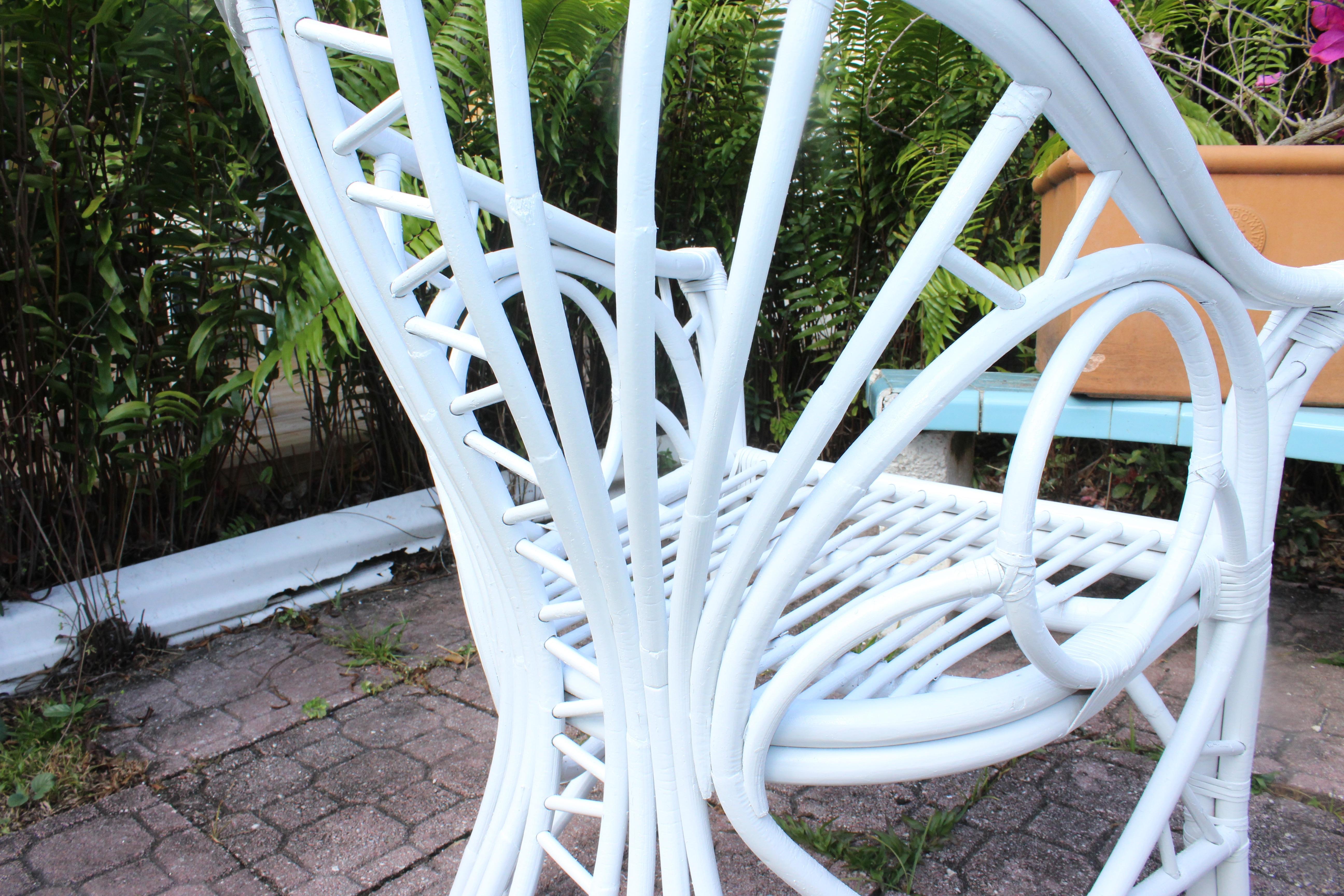 Pair of Rare Vintage Midcentury Modern Rattan Brighton Style Arm Chairs. Features geometric details from all angles. Refinished in weather resistance gloss white. Bamboo Rattan Chippendale design with winged arm rest. 