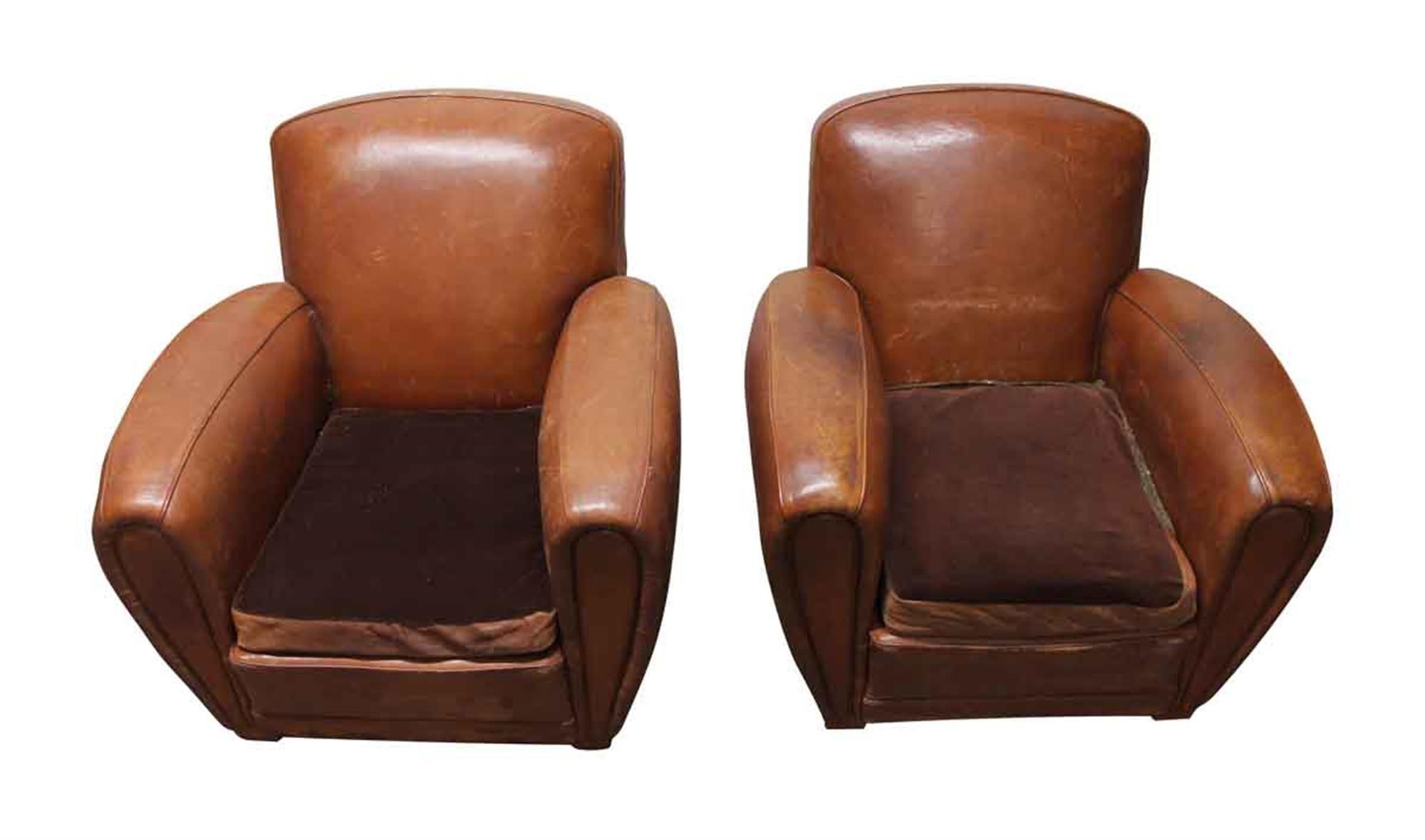 Wide brown leather club chairs from 1970s France. One chair is slightly different with the arm seams. They have general wear and tear from age and use. Priced as a pair. This can be seen at our 400 Gilligan St location in Scranton, PA.