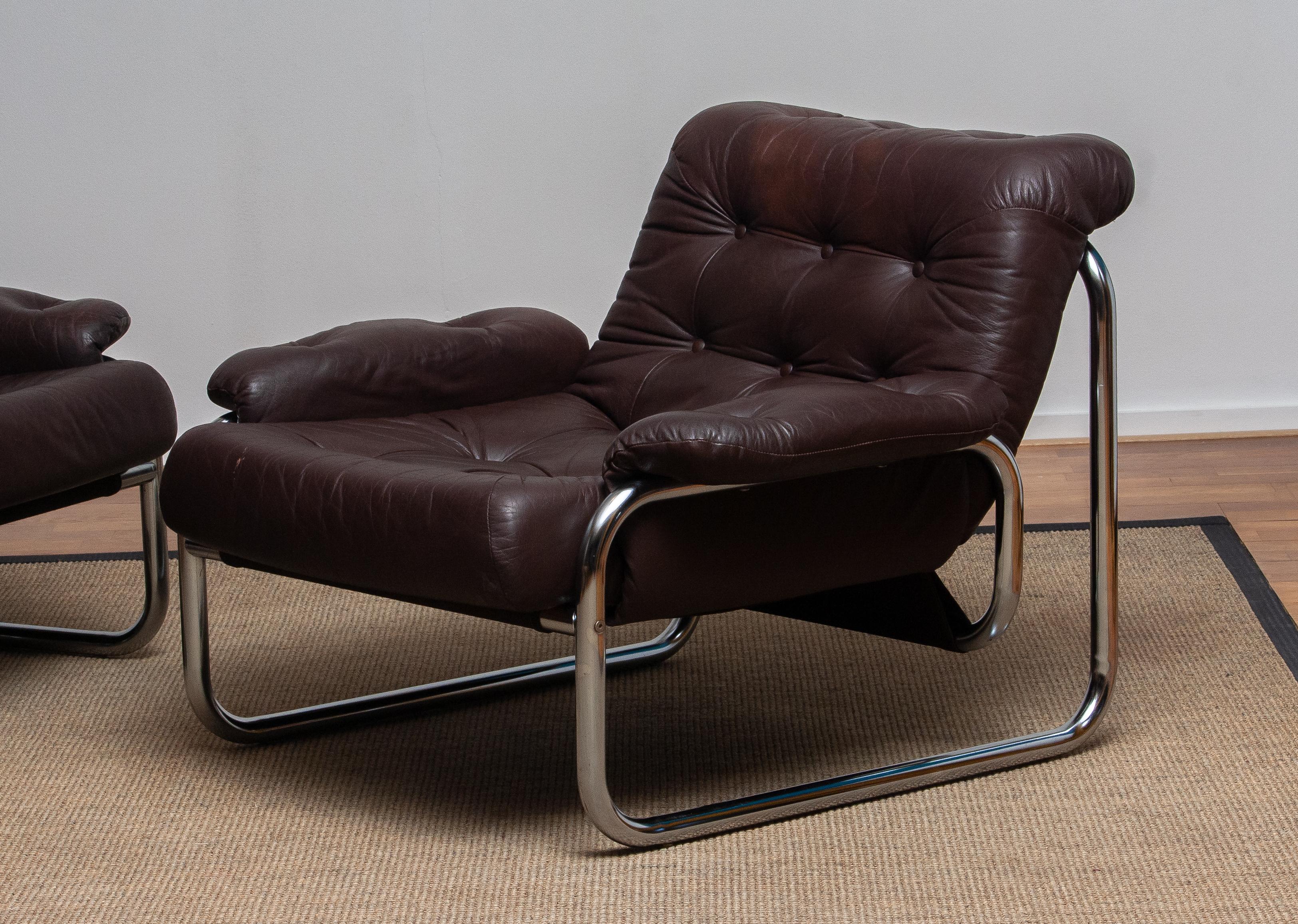 Pair of lounge / easy chairs model 'Troligen' designed by Johan Bertil Häggström for Sved Form, Sweden
These chairs are made of a tubular metal chromed frame with brown leather cushions and armrests.
They are in a wonderful condition.
Produced in