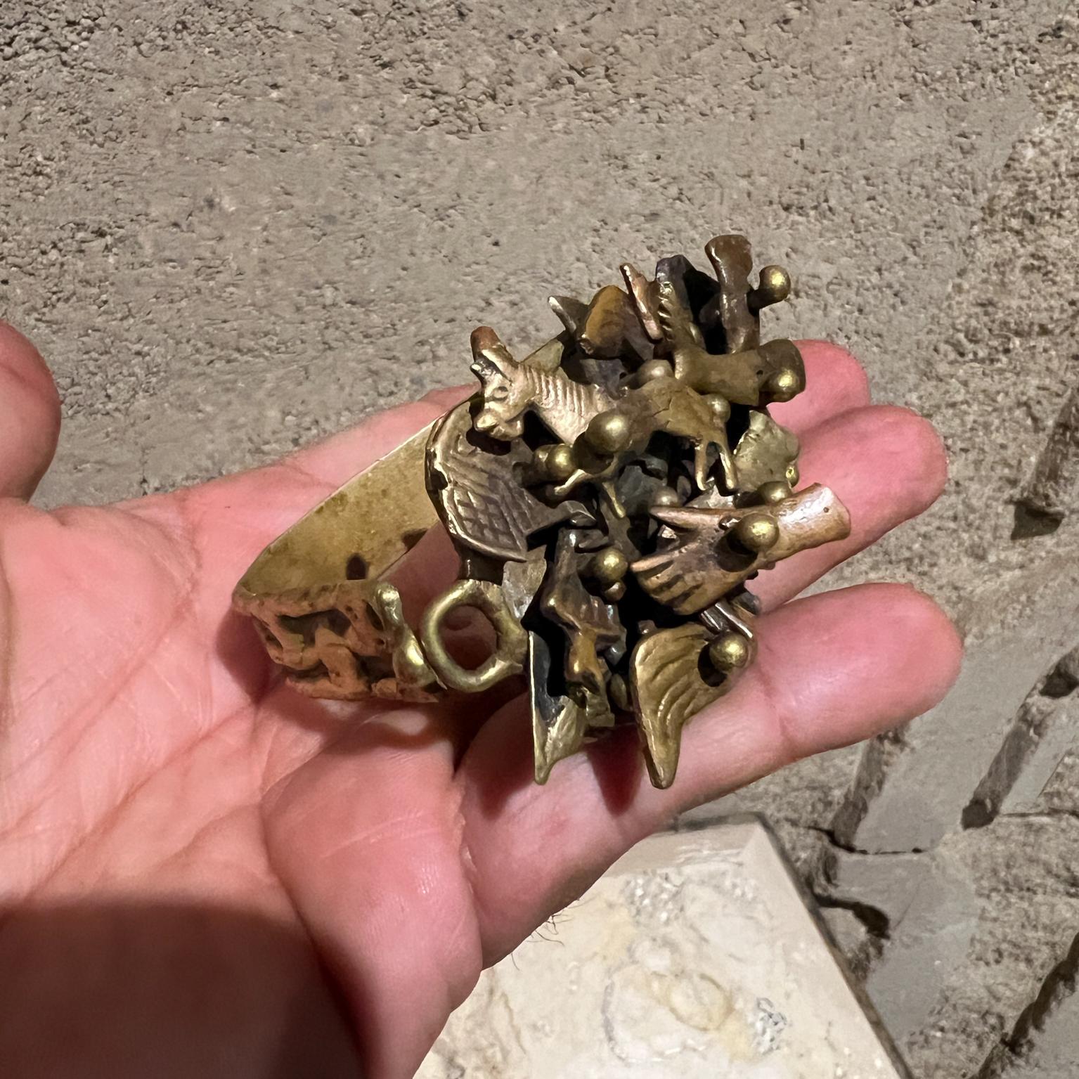 AMBIANIC presents
1970s Pal Kepenyes Brass Bracelet Cuff Milagros Series 
Brutalist inspired
3h x 2.25 w x 1.75
Signed at bottom
Original vintage unrestored condition.
Refer to images