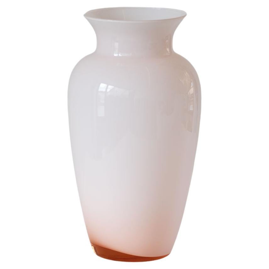 1970s pale pink Italian Murano glass Vase. This tall vase is made in opaque glass with a deep pink transparent flourish at the base.  
