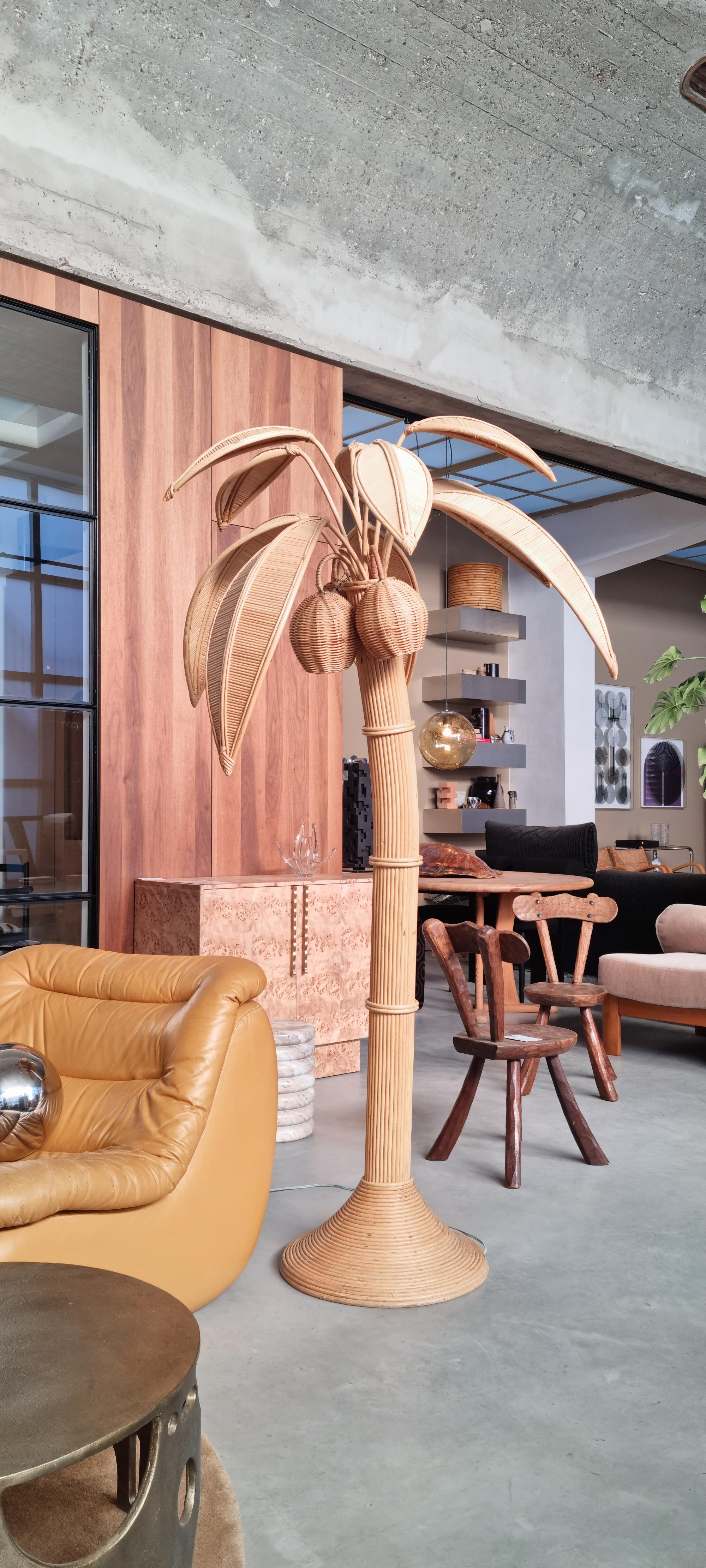 This floor lamp, designed by Mario Lopez Torres in the 1970s, adds a touch of tropical charm to any space. Crafted from rattan and wicker, it stands 195 cm tall in the shape of a palm tree, highlighting detailed craftsmanship and natural