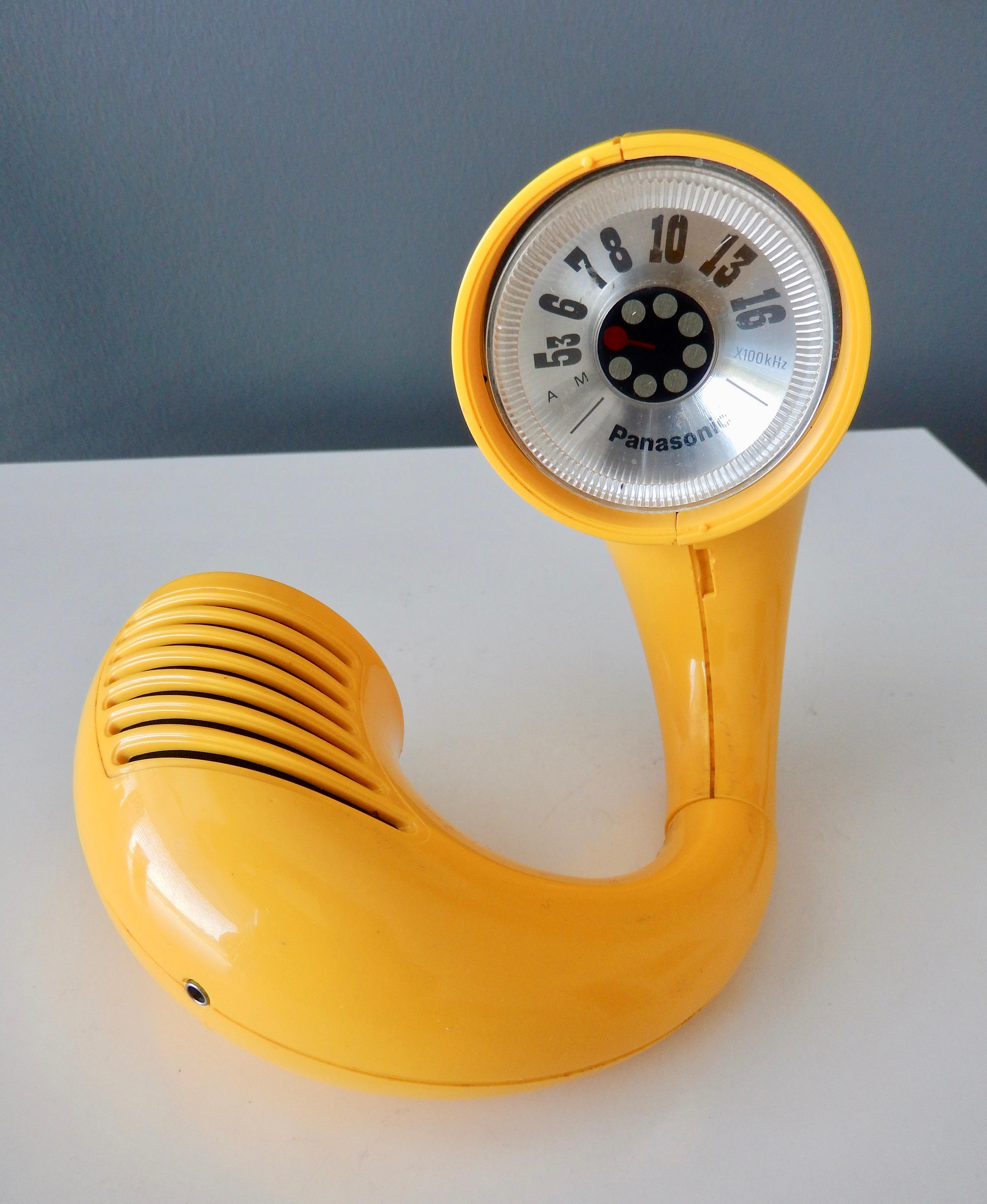 A transistor radio produced by Panasonic, Japan in the early 1970s. Donut shaped, this novelty radio was designed to wear on the wrist. The radio also has a swivel hinge so it can be freestanding . AM reception only. An example of this iconic radio