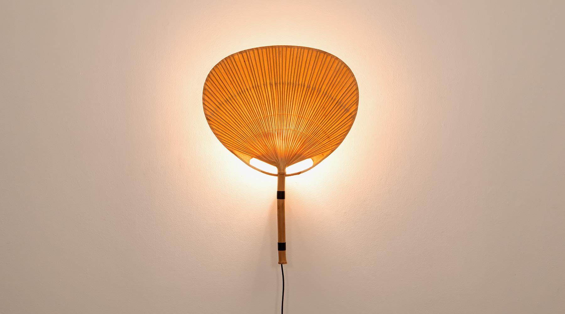 Sconce or wall lamp, paper, bamboo, Germany, 1973.

Wall lamp by Ingo Maurer from 1970s. Bamboo combined with paper gives a delicate bright light. The sconce from the series 'Uchiwa' act to the wall like an art object. Manufactured by Ingo Maurer.
