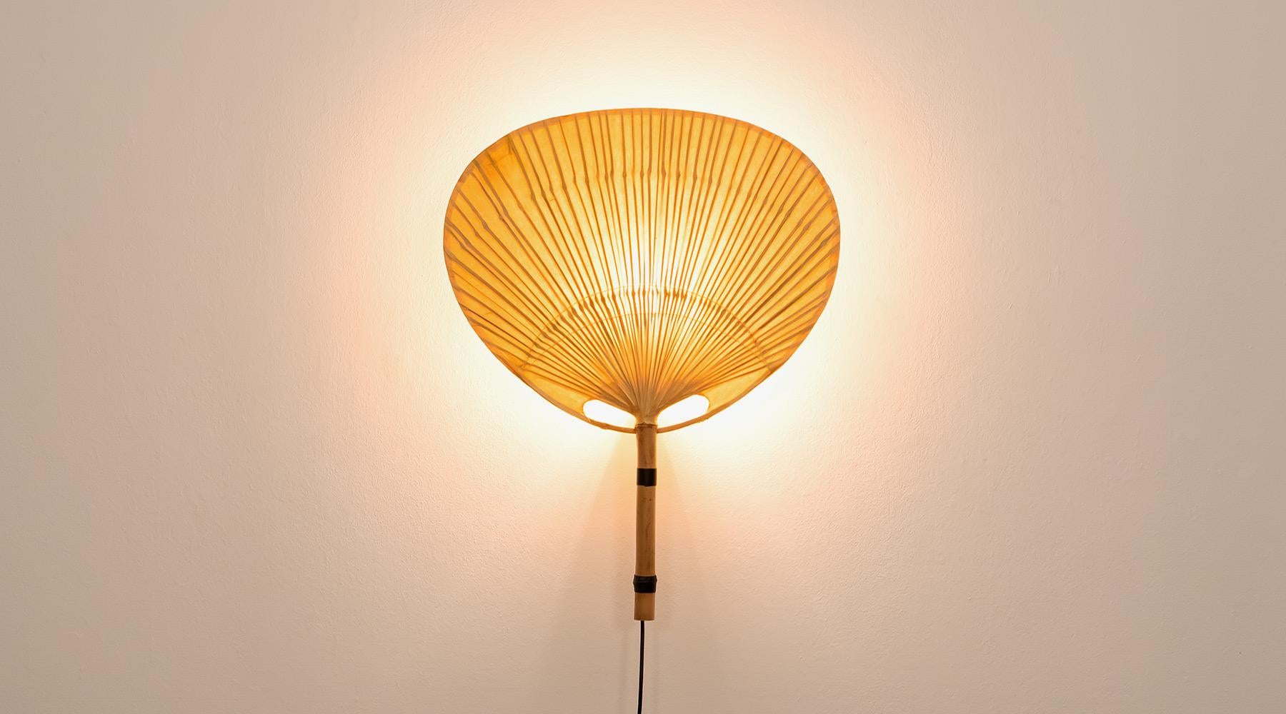 Sculptural wall lamp, paper, bamboo, Germany, 1973.

Delicate 1970s bamboo and paper wall lamps by Ingo Maurer. The wall sconce from the so-called series 'Uchiwa' give a delicate warm light and appear on the wall like sculptural objects.