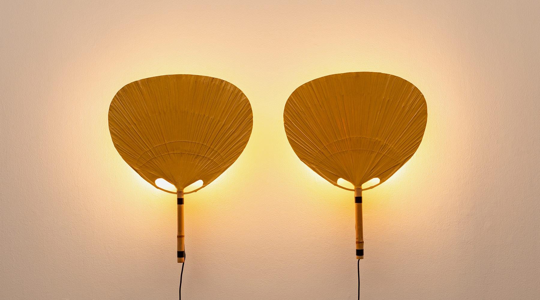 Sculptural wall lamps, paper, bamboo, Germany, 1973.

Delicate 1970s bamboo and paper wall lamps by Ingo Maurer. The wall sconces from the so-called series 'Uchiwa' give a delicate warm light and appear on the wall like sculptural objects.