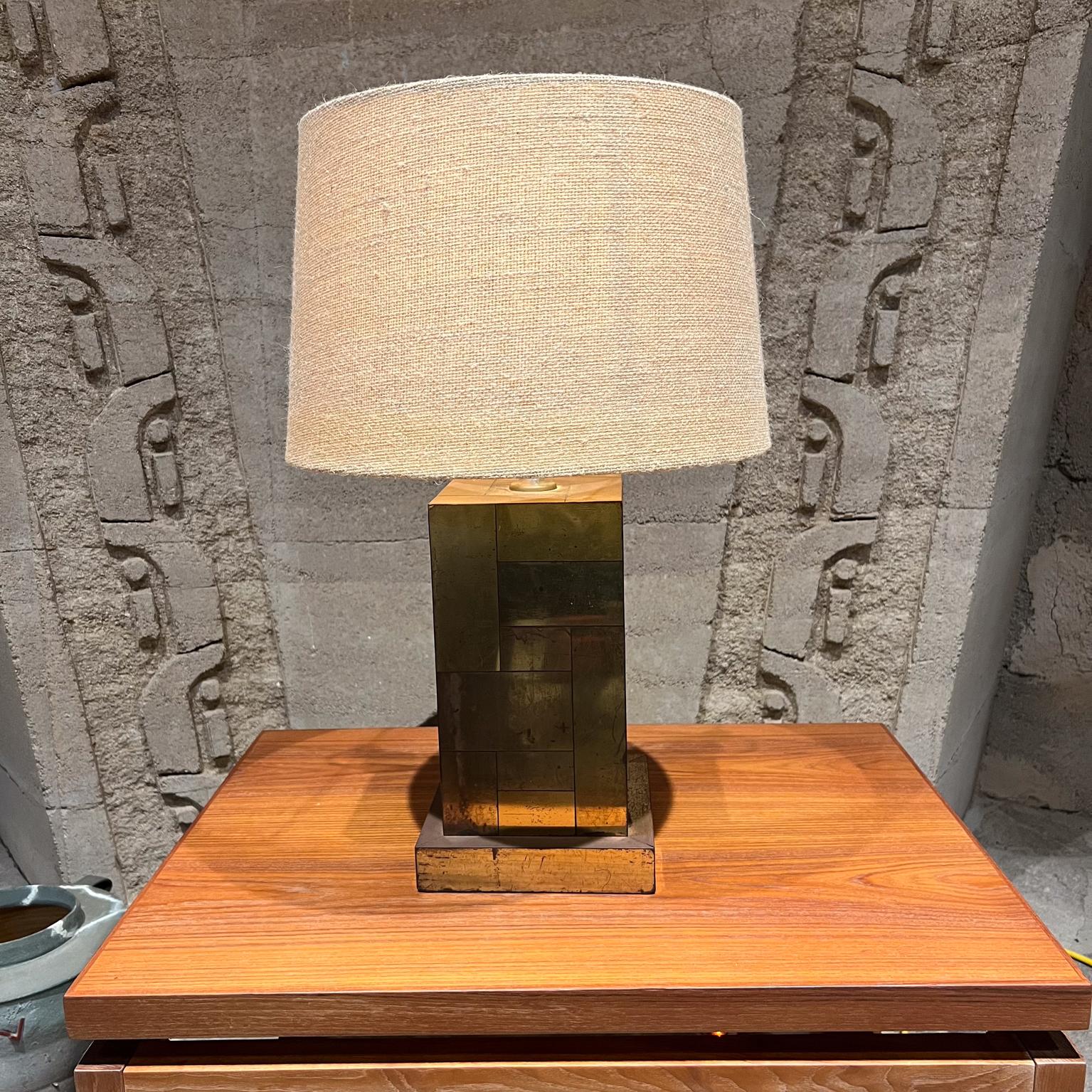 
1970s Cityscape Patchwork patinated Steel Column Table Lamp Style of Paul Evans
Unmarked
19 h to socket x 7.5 x 7.5
Rewired new socket, plug & gold twisted cord.
Preowned original fair vintage condition with signs of wear.
Patina shows. No lamp