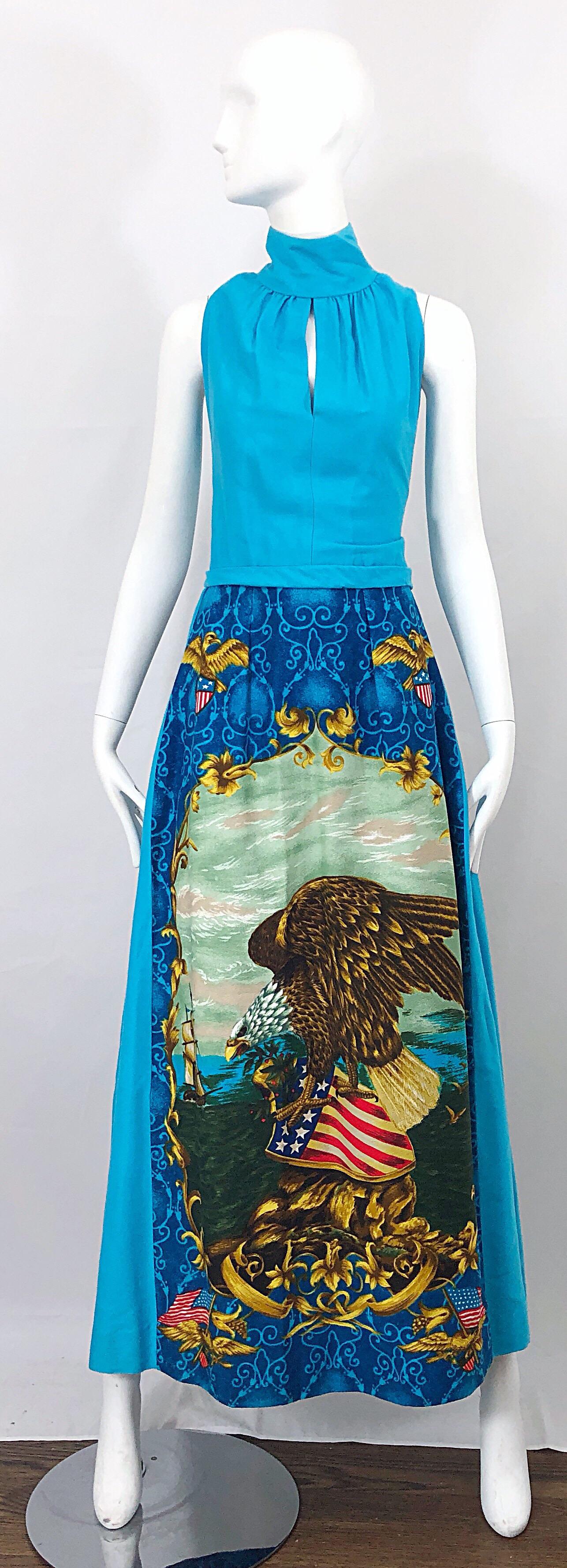 Incredible vintage 1970s patriotic maxi dress! Turquoise blue base, with vibrant colors of red, white, blue and gold throughout. Peek-a-boo cut out above the bust, with a high neck. Print on the front skirt is also on the back skirt. Soft felt