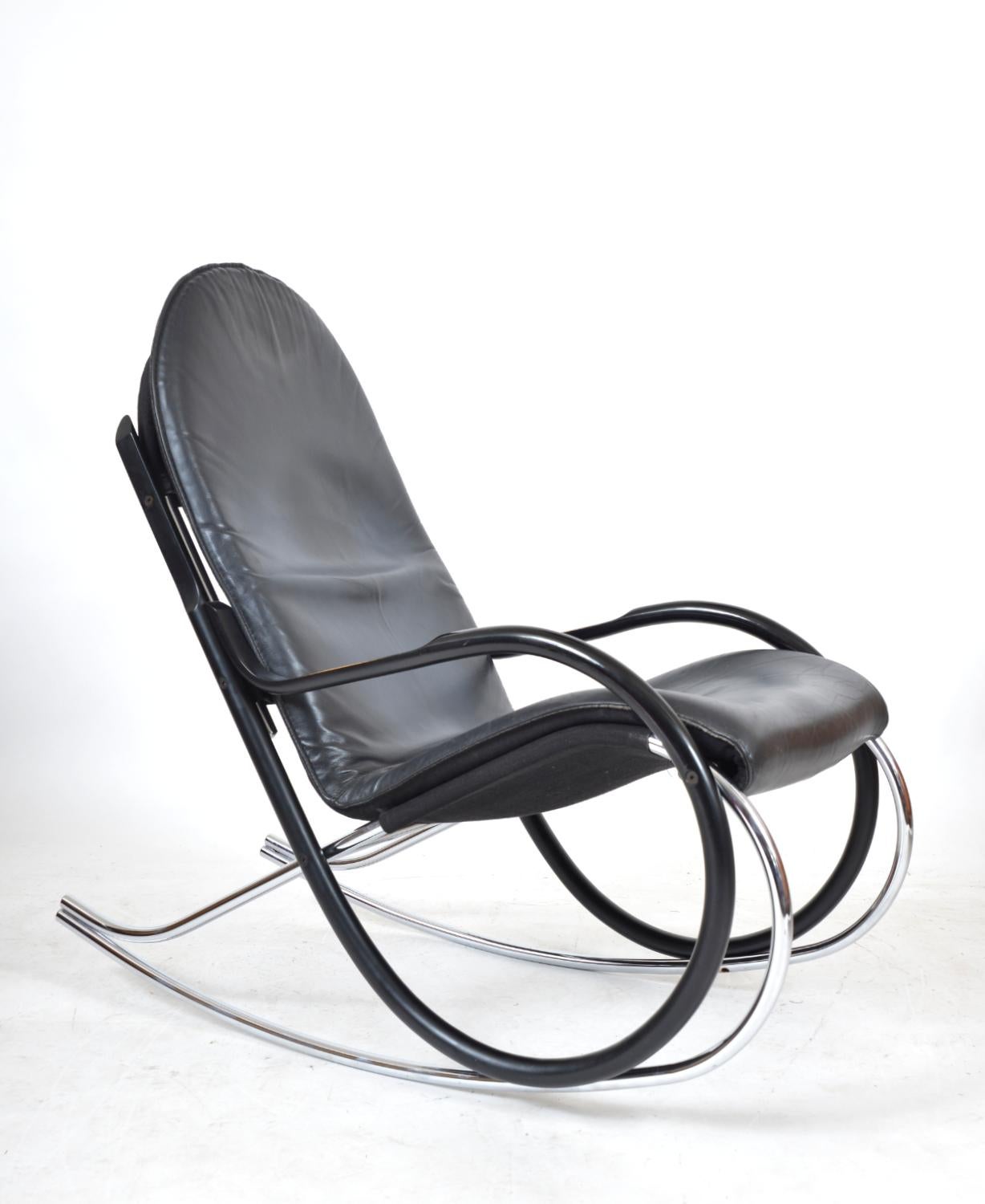 This is a fine example of a “Nonna” rocking chair designed by Paul Tuttle in 1972 for Strässle International, Switzerland. The materials used on this chair are an attractive combination of tubular chrome, ebonised bentwood, leather and canvas. The