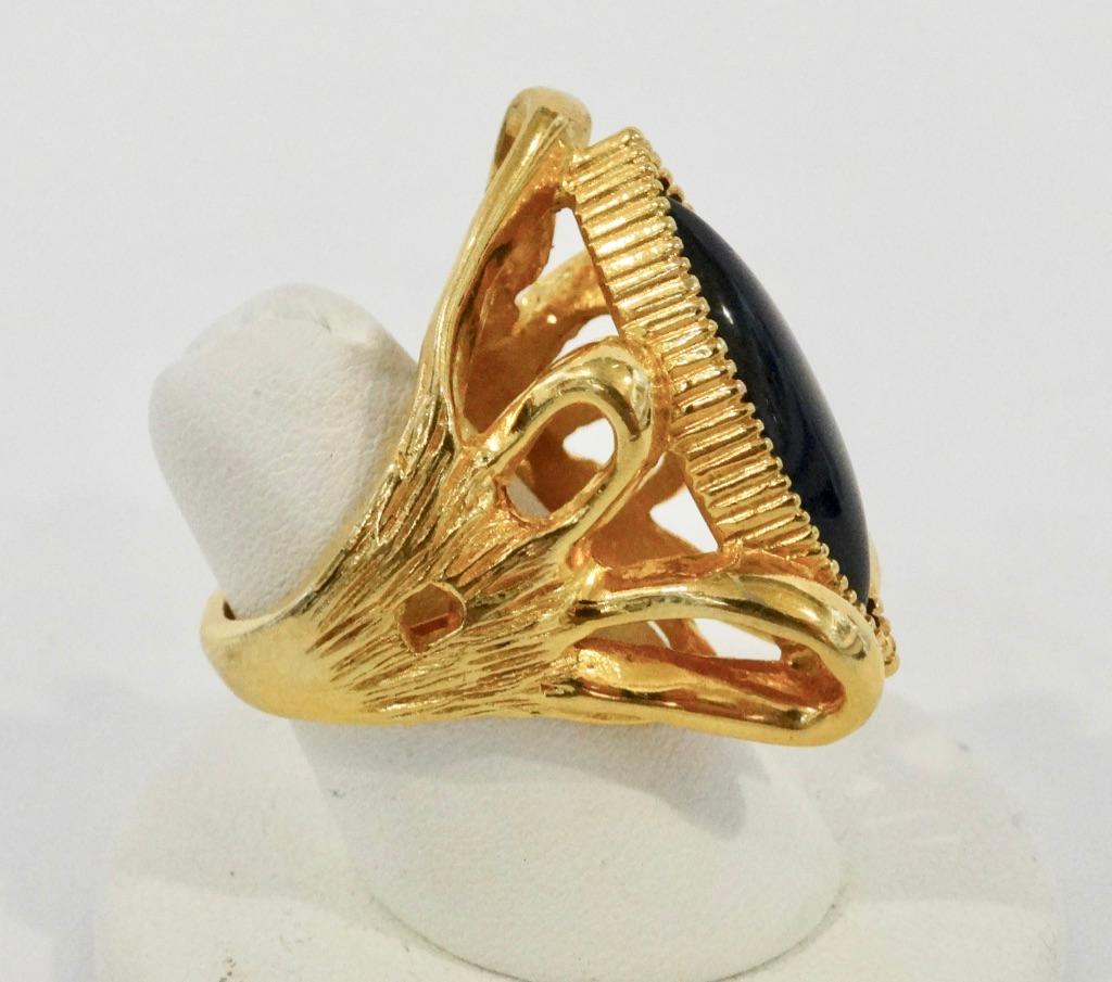 Provide some eye candy with this amazing cocktail ring! Circa 1970s, this Pauline Rader Victorian revival cocktail ring features a beautiful and intricate gold-plated setting with a deep black marquis cut onyx center stone. The perfect ring to wear