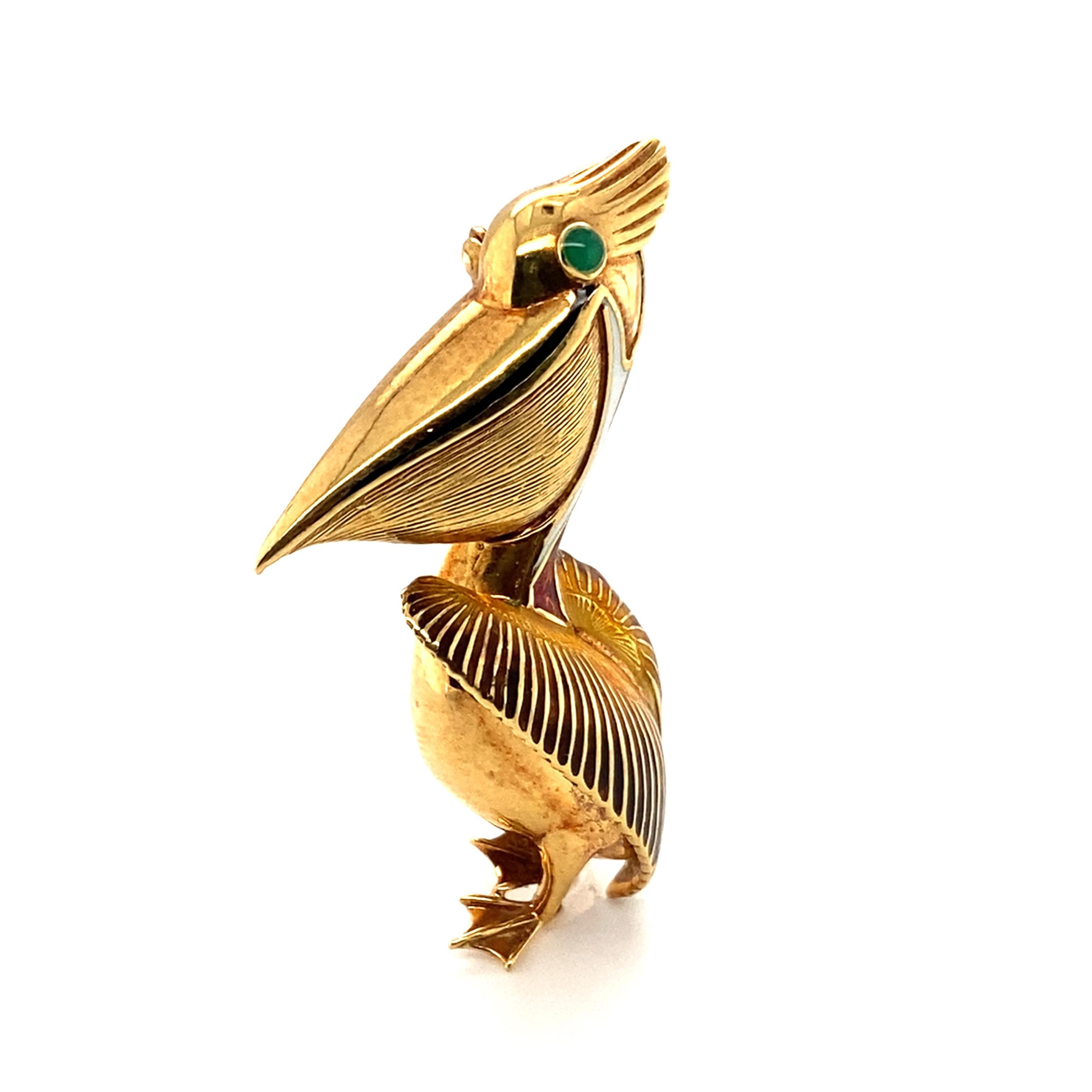 Item Details: 
Metal: 18 Karat Yellow Gold 
Weight: 10.6 grams 
Measurements: 2 inches long x 1 inch wide

Item Features:
Beautifully crafted 1970s vintage enamel pelican set in 18 karat yellow gold. Has intricate enamel work and a green emerald