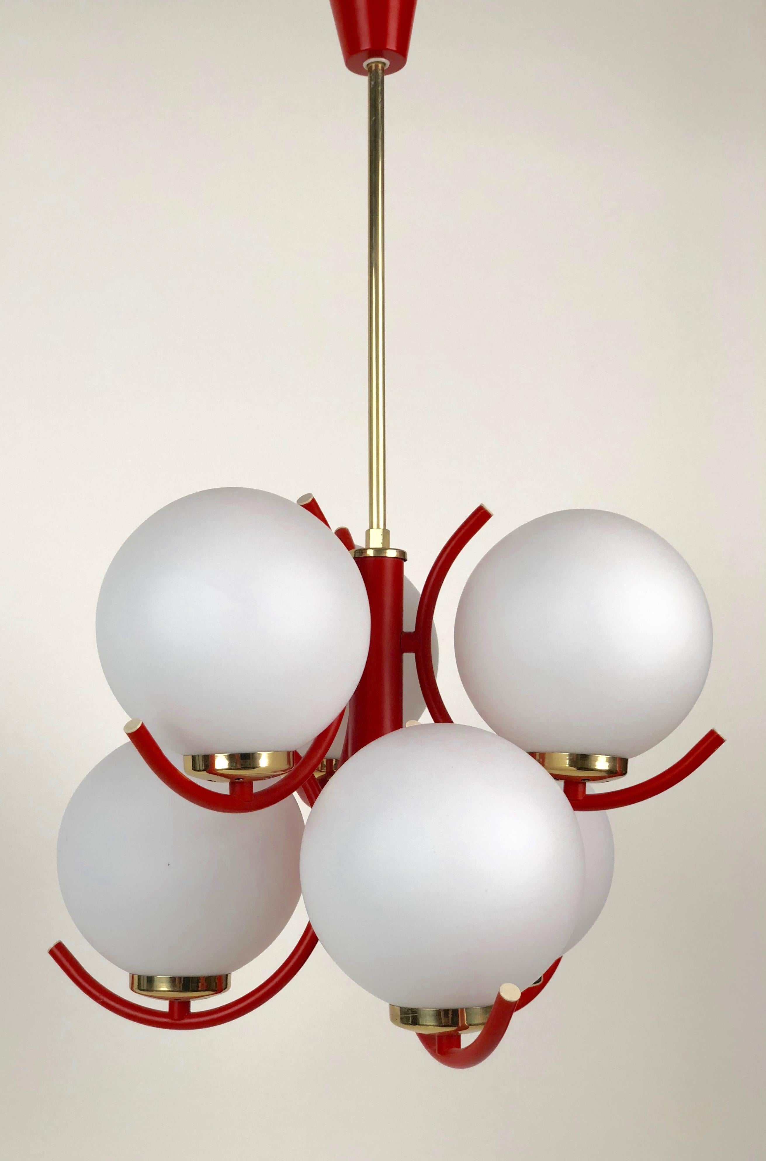 A beautiful pendant lamp in coral color with brass trim. The 6 glass globes are mat opaline glass.