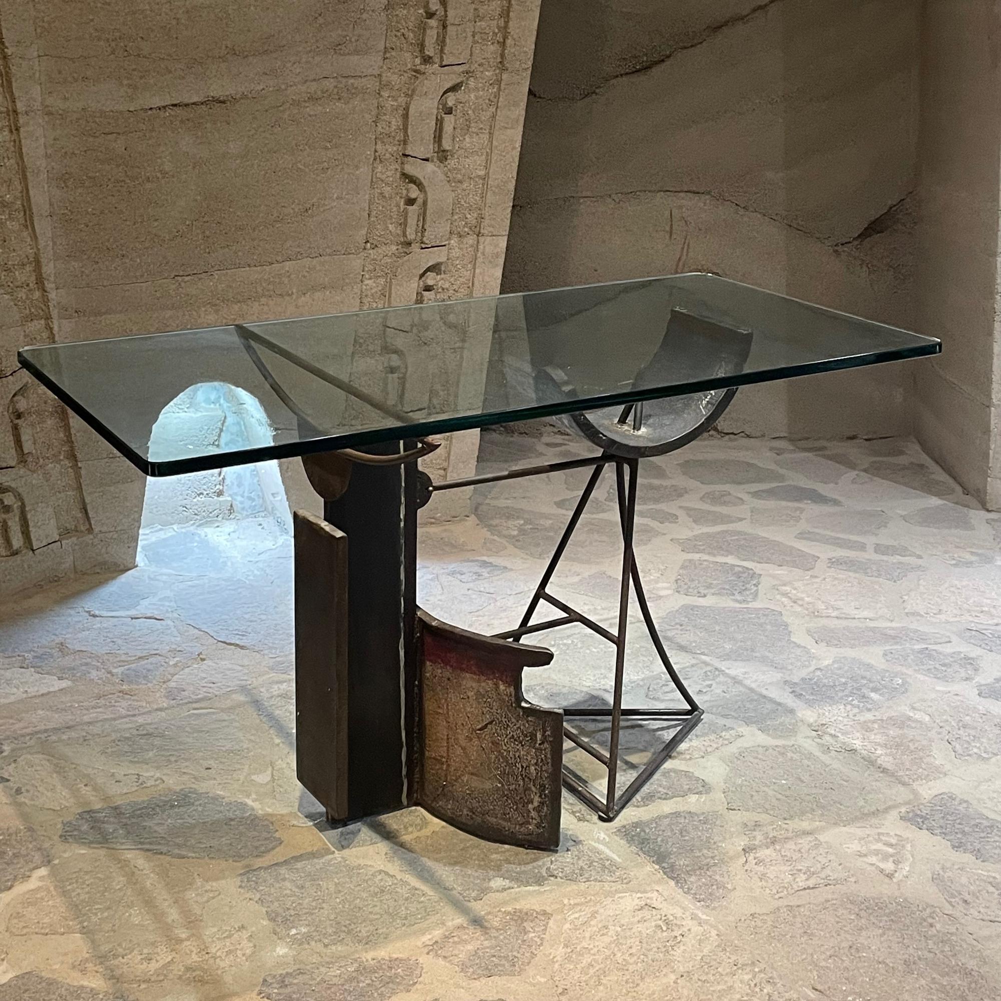 1970s rare custom Brutalist table desk. A work of art. The base features Solid Iron metal sculpture design by Jaime Artigas.
Abstract sculptural Modern shape with Patina. There are two sections attached by screws. Crafted in Steel Bronze. 1970s