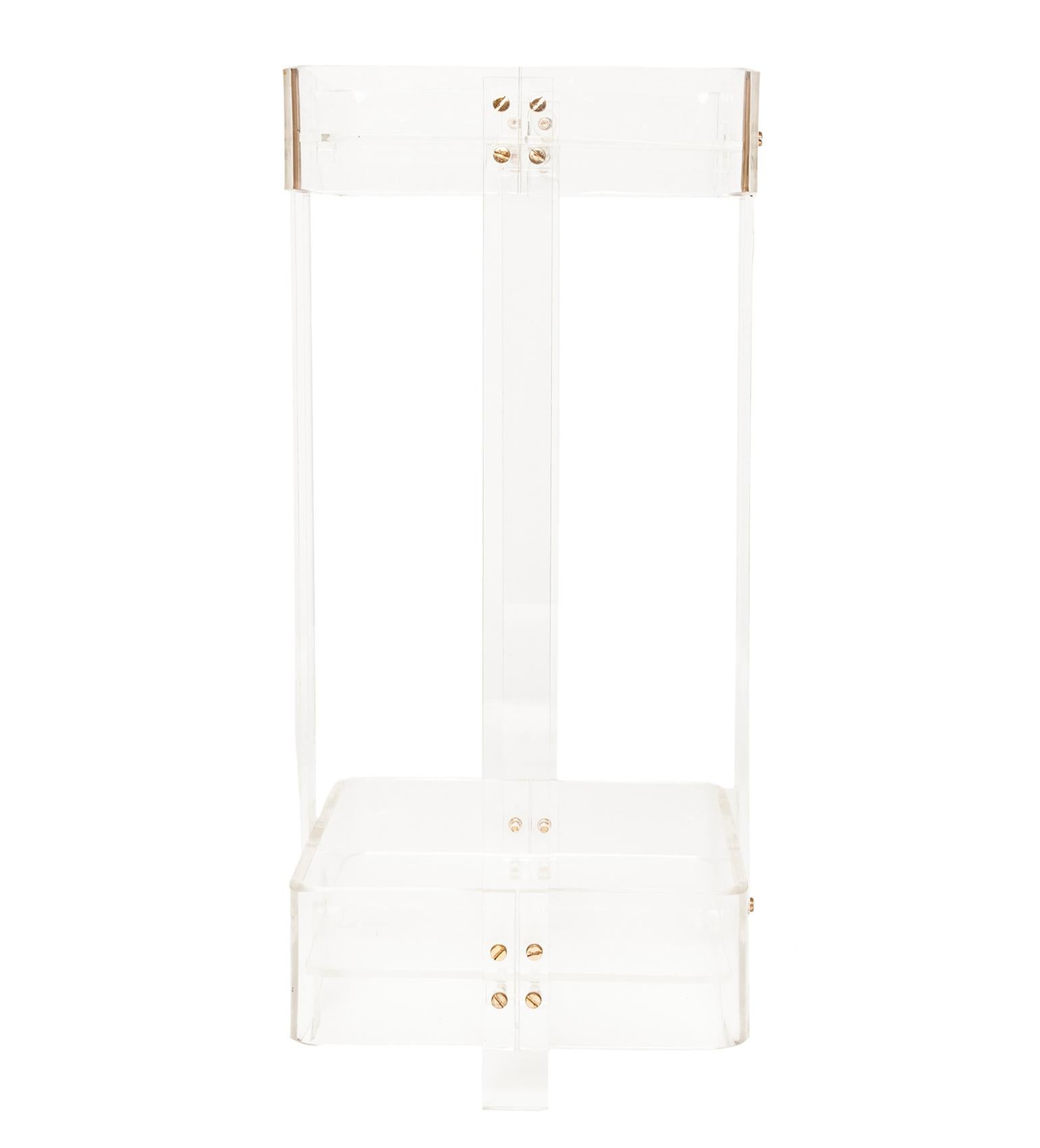 A Perspex two-tiered side table, with brass screws
Spain, circa 1970.