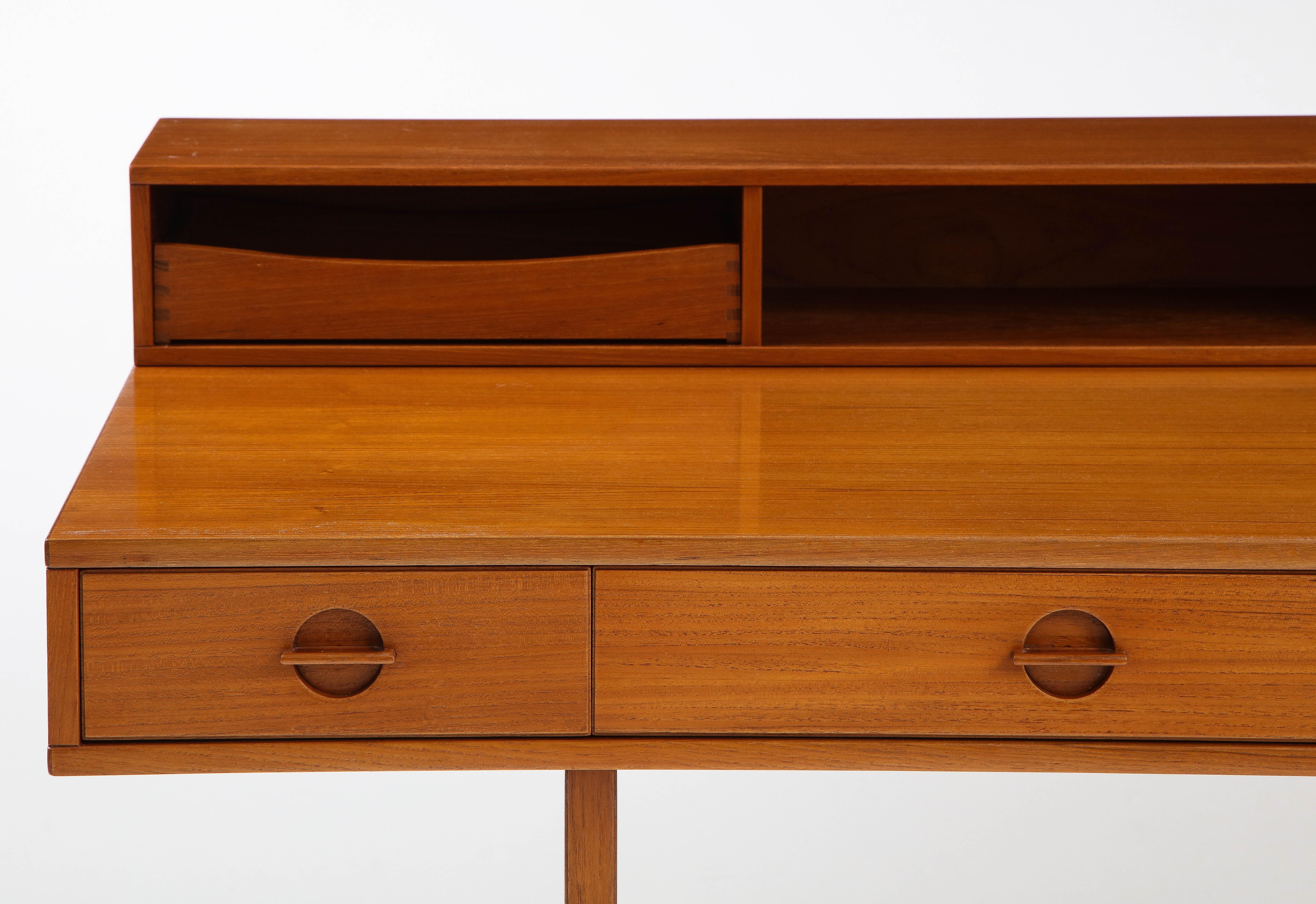 Stunning 1970's Mid-Century Modern teak flip top executive teak desk designed by Peter Lovig Nielsen for Dansk, fully restored with minor wear and patina due to age and use.