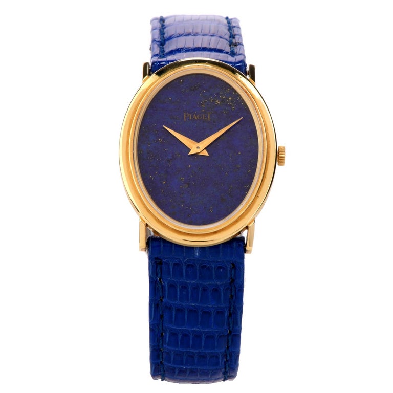 Adore the bright hue of this Vintage Piaget Lapis 18K Gold Mechanical Ref 9861 Leather Watch!  This 1970's watch as a genuine oval lapis lazuli dial, with an 18 karat yellow gold case.  The cobalt blue strap is composed of genuine leather with a