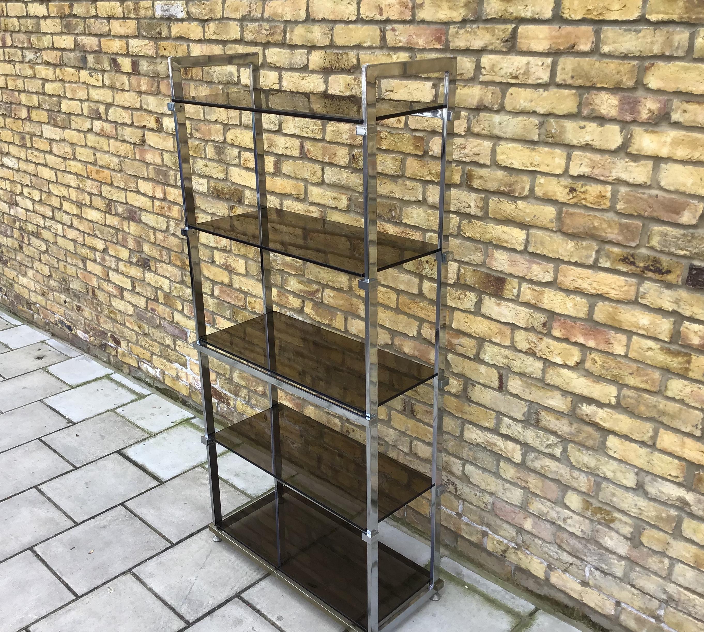 Tinted glass with adjustable supports chrome plated and adjusting feet
Large 1970s shelving in a simple clean design. Cc Pieff.