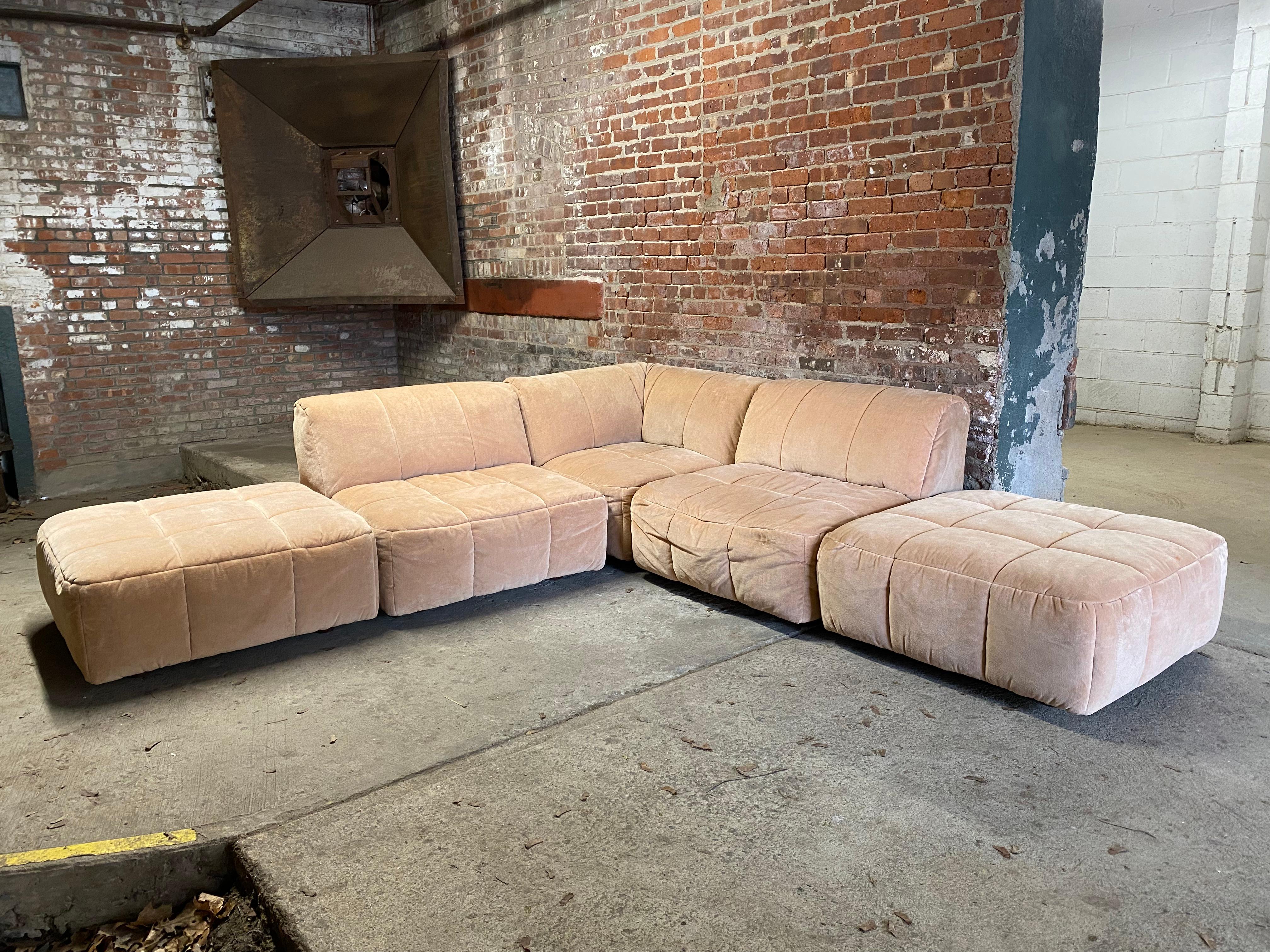 Five piece Pierre Cardin modular sofa. Multiple configurations and very comfortable. The set consists of: 2 ottomans, 2 armless chairs and 1 corner chair. Original velvety peach upholstery. Removable screw in wood feet. Some pieces still retain the