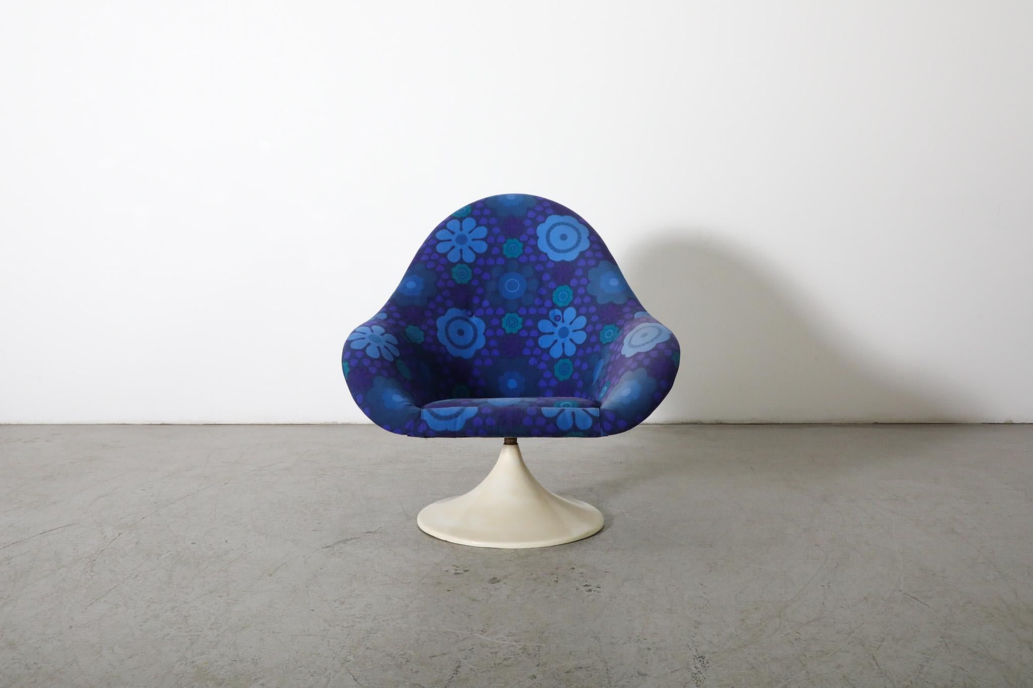 1970's blue tulip swivel chair by TopForm, inspired by Eero Saarinen and Pierre Paulin. This playful lounge chair features a single-form upholstered fiberglass armchair shell, adorned in a lovely vintage blue 1970s flower pattern and a white swivel