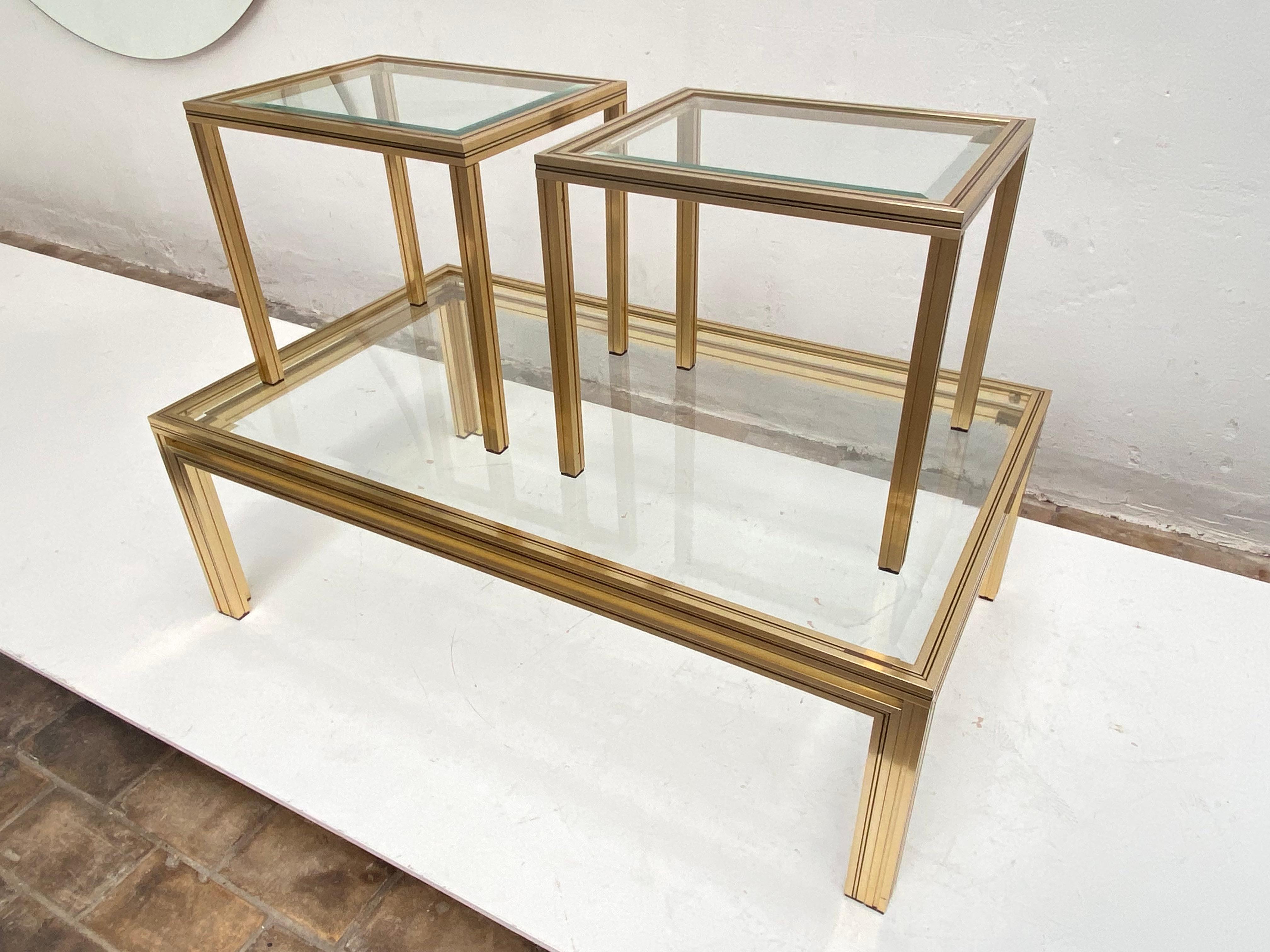 Large Hollywood Regency coffee table and 2 side tables by Pierre Vandel Paris 1970's

Gold colour anodised Aluminium frames and hardened facet cut glass tops

Marked with manufacturers label to each table 

A minimal yet glamorous looking