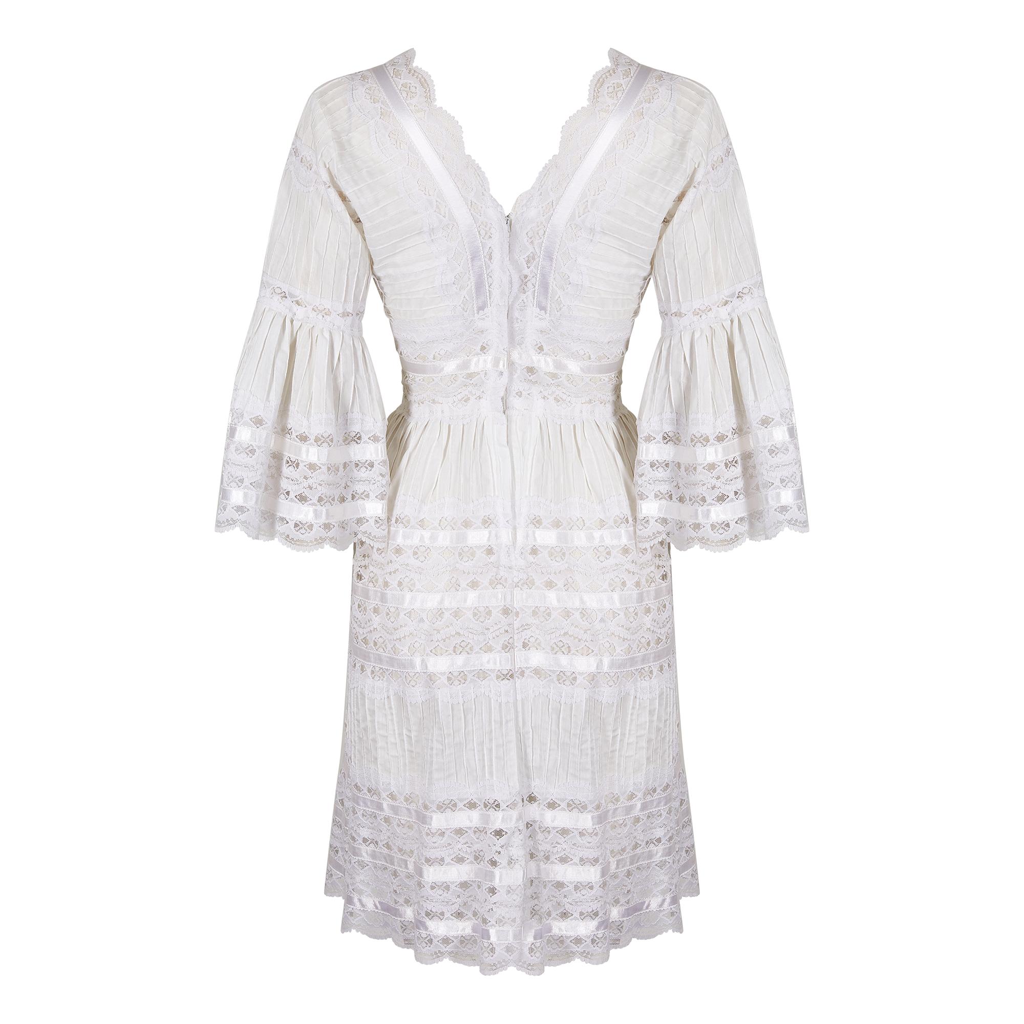 This original 1970s Mexican made pin-tuck tiered cotton lace and ribbon dress is a quality export version with a higher proportion of lace and ribbon work than the traditional festival or wedding dresses from the region. With a deep V neck and back