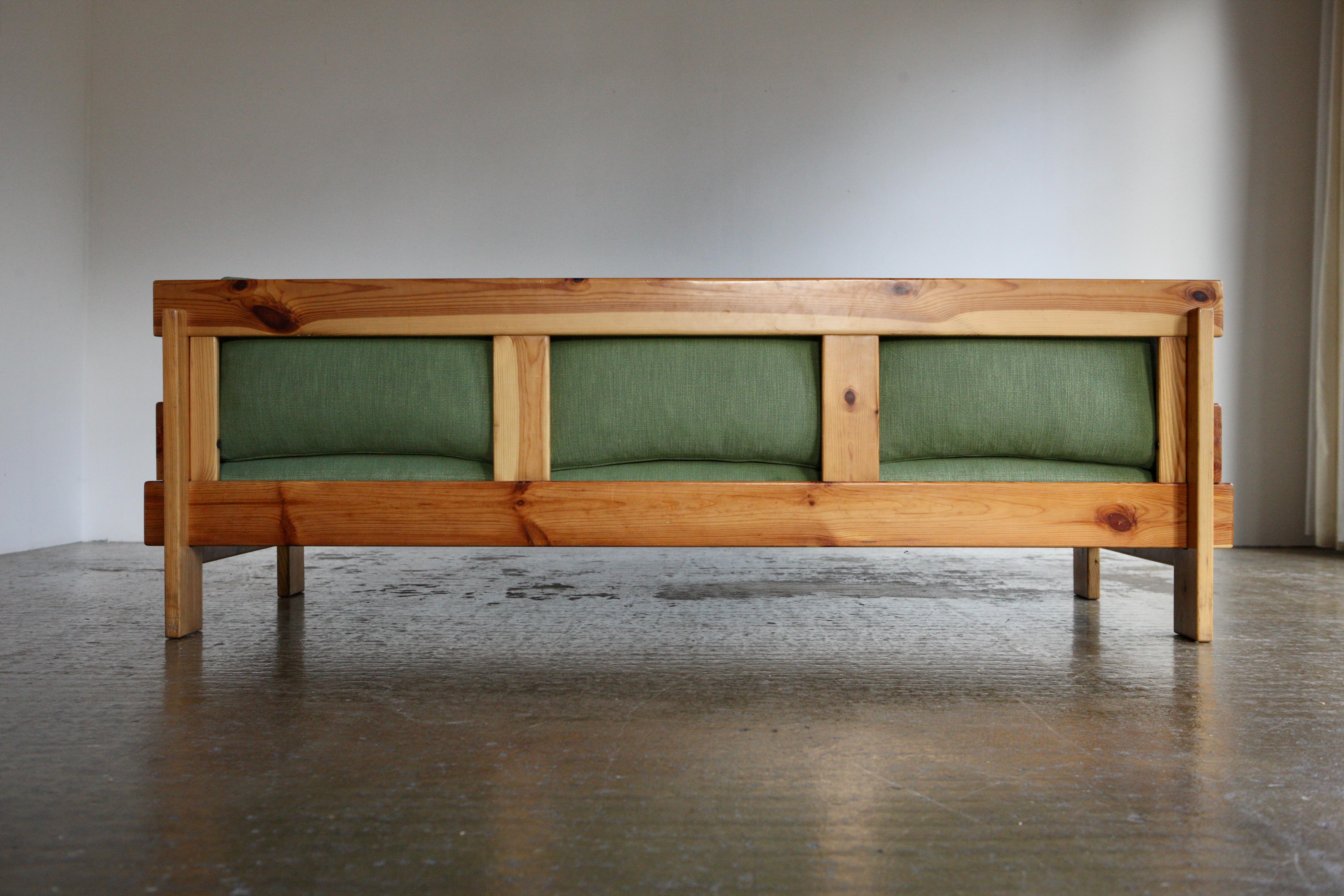A 3 seater sofa equipped with brand new moss green linen upholstery with foam and feather cushions. The cushions have a been sensitively designed to slot into the frame which has an ingenious construction of interlocking pine panels. 