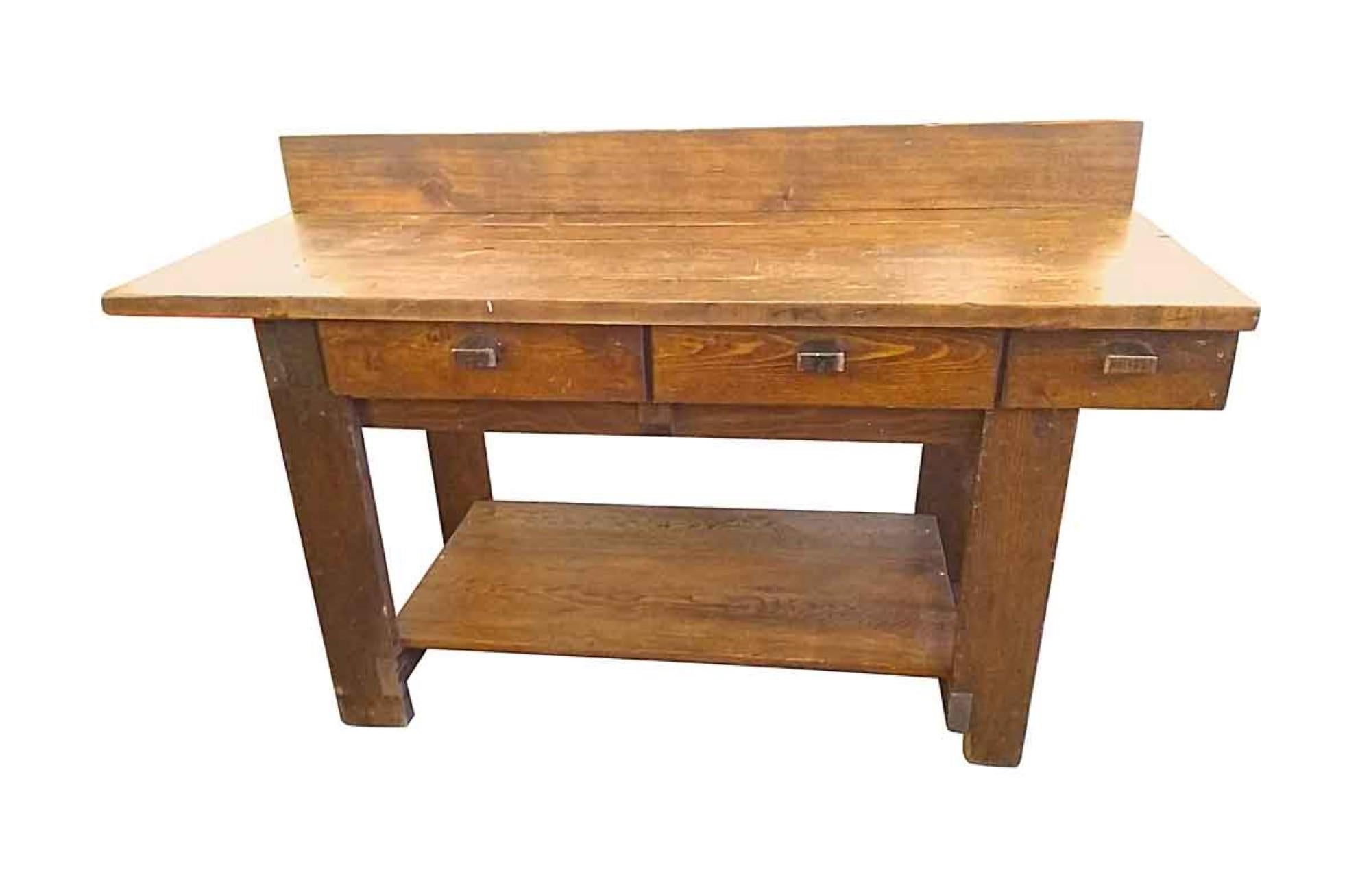 1970s light wood tone large industrial style work bench table made of pine with three drawers. Overall height at back of table is 43 inches. Front of table is 36.5 inches high. This can be viewed at one of our New York City locations. Please inquire