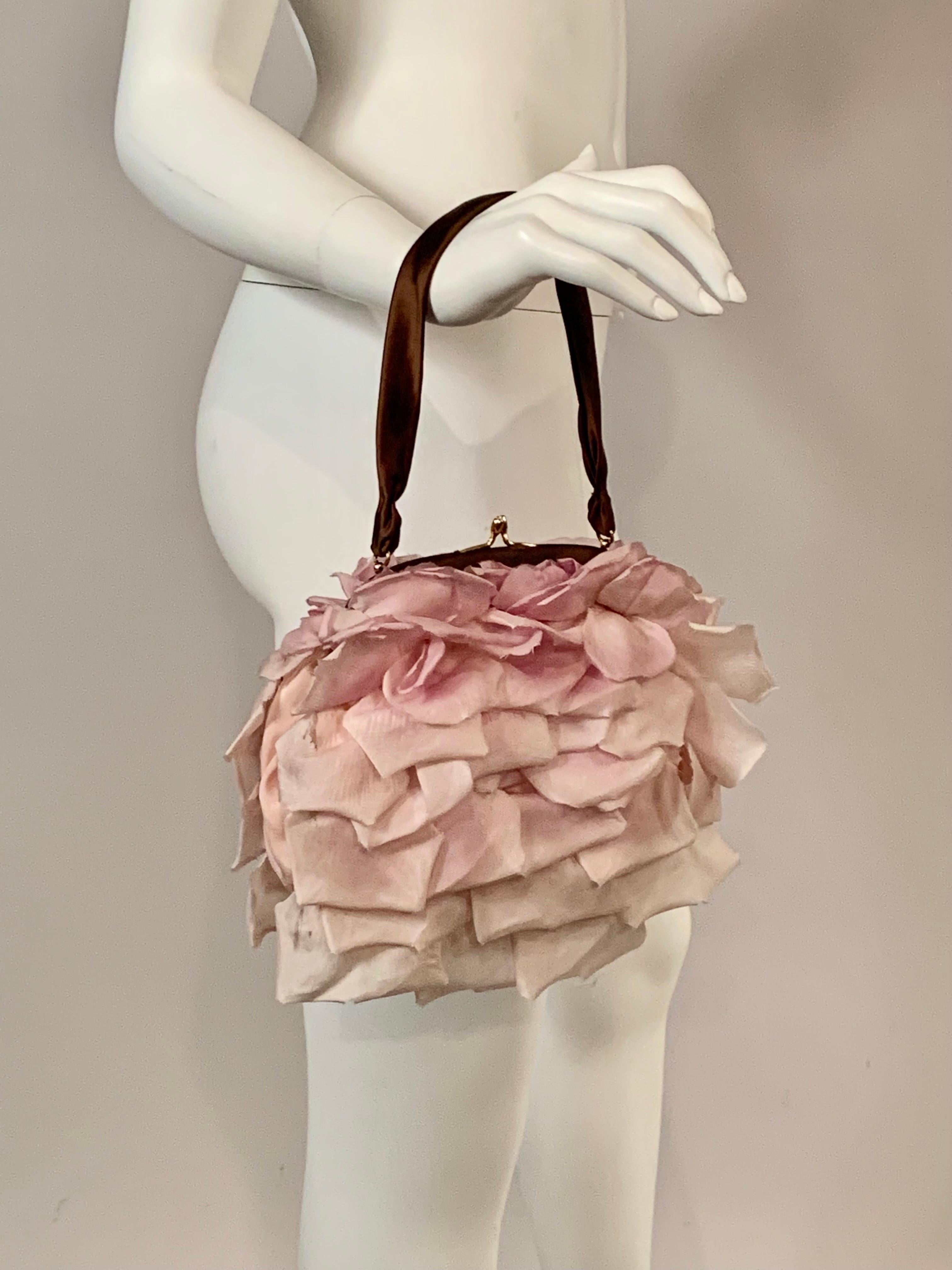This is such a charming and romantic evening bag, Made in France for Bergdorf Goodman in the 1970's.  The frame and fabric handle are made from deep green satin, the color of a rose stem or leaves.  The bag is covered front and back with silk rose