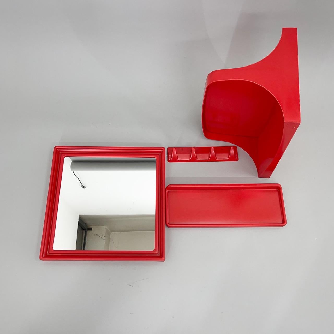 Four piece set made of plastic in a very nice red colour. Beautiful collection from the 1970's. 
The Mirror is 40 cm wide and 40 cm high, the hanger is 26 cm long, 6 cm high, the smaller shelf is 40 cm long and 14 cm deep, the larger shelf is also