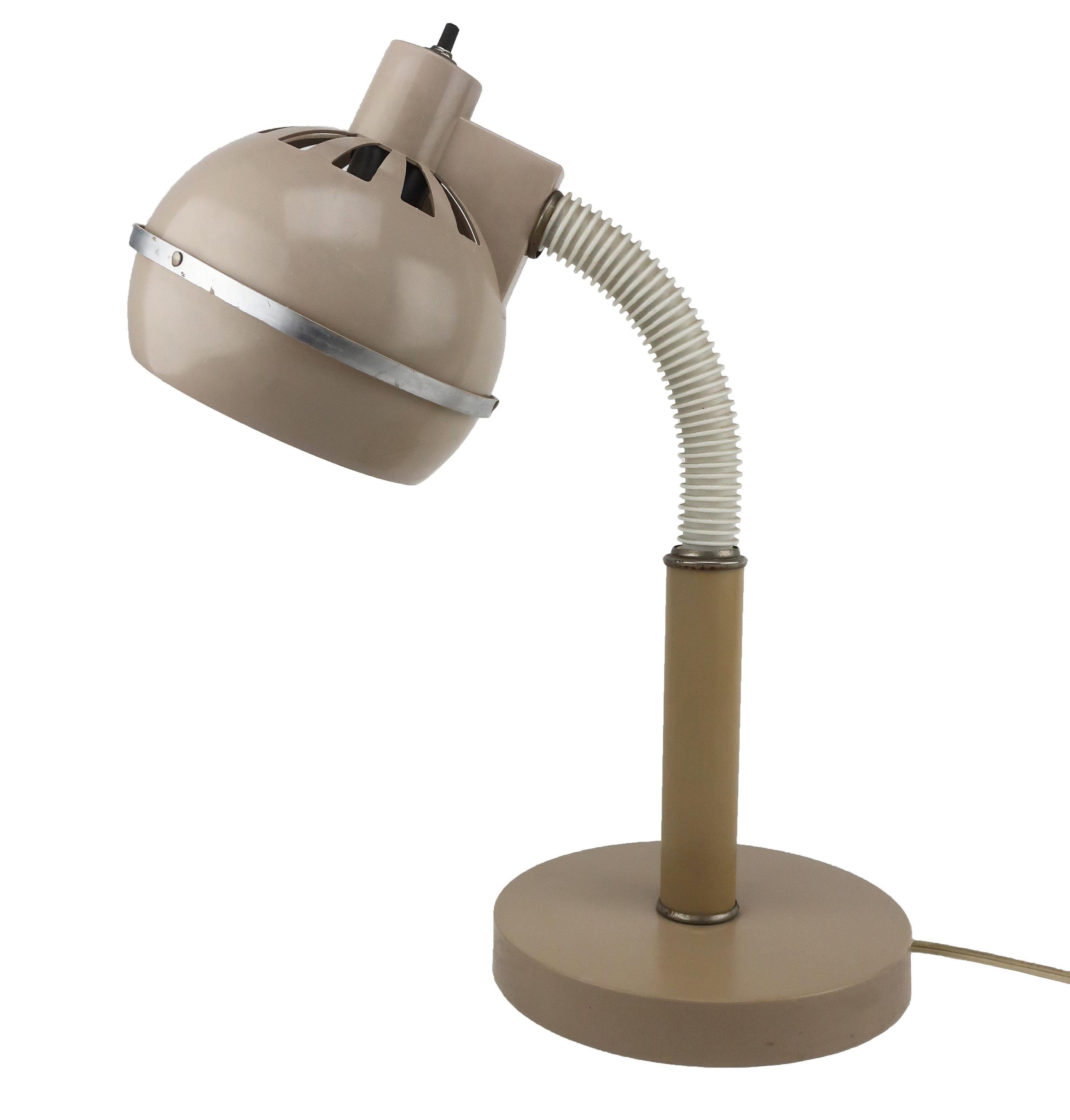 Vintage 1970s adjustable gooseneck desk lamp. Light brown plastic base and shade, white gooseneck, and chrome accents. 

7