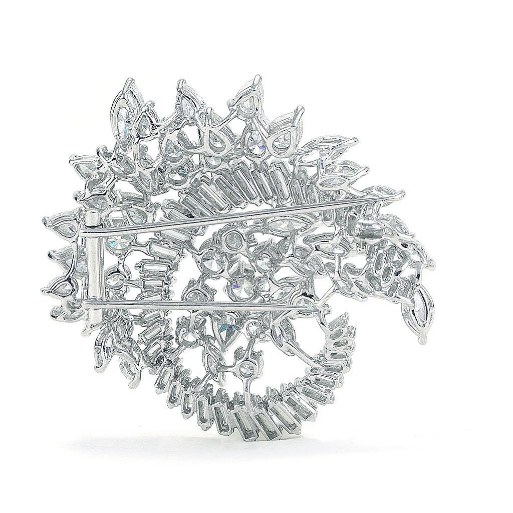 This pin is made of platinum and weighs 15.70 DWT (approx. 24.42 grams). It contains 10 round diamonds weighing 3.00 CTTW, 41 baguette G-H color, VS clarity diamonds weighing 5.00 CTTW, 16 pear diamonds weighing 4.00 CTTW, and 23 marquise diamonds