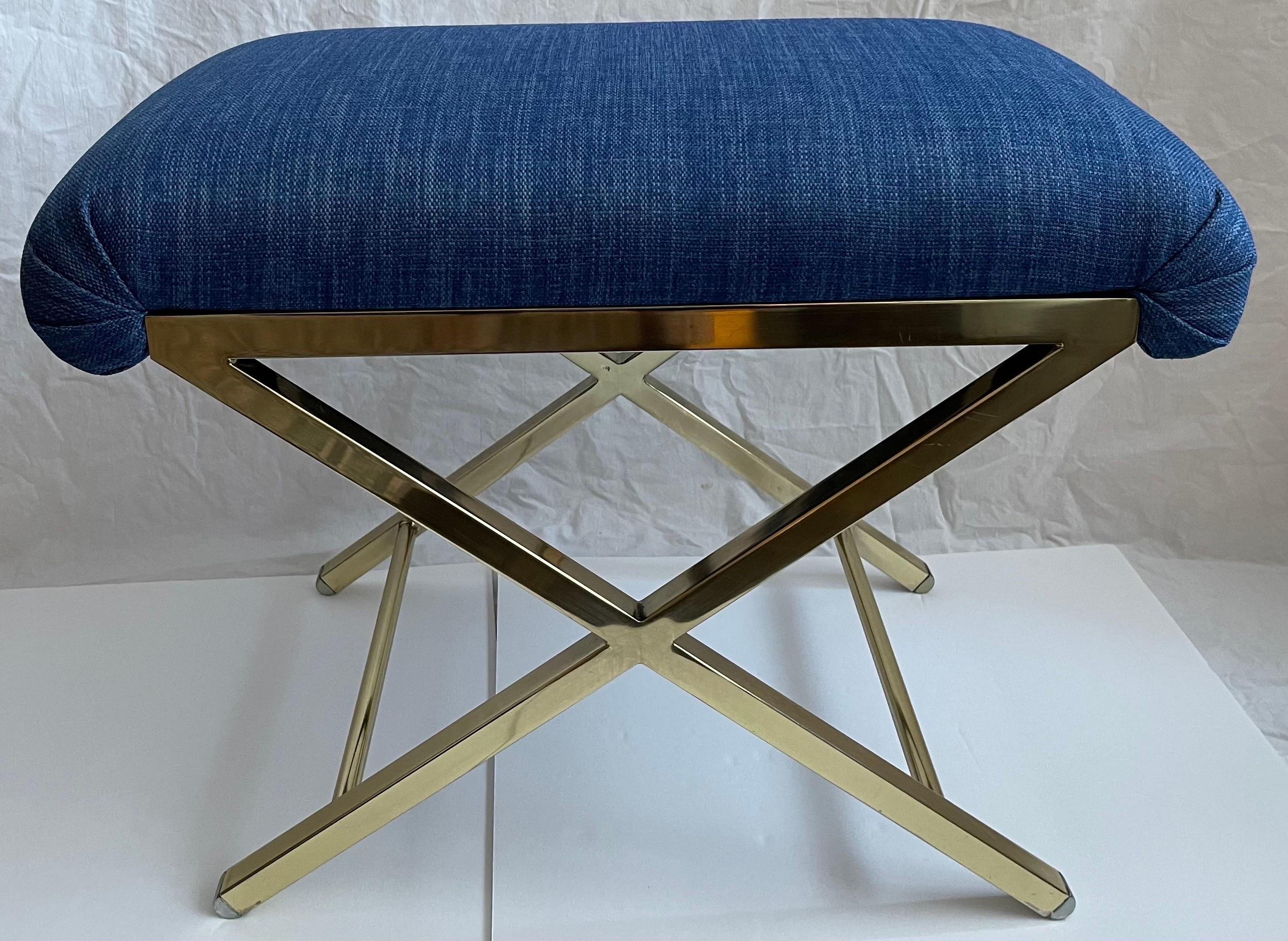 1970s Polished brass X-bench. Newly upholstered in Kravet blue woven performance fabric.
Performance fabric makes it suitable for high traffic areas.
No makers mark or brand stamp. The bench is heavy and well made.