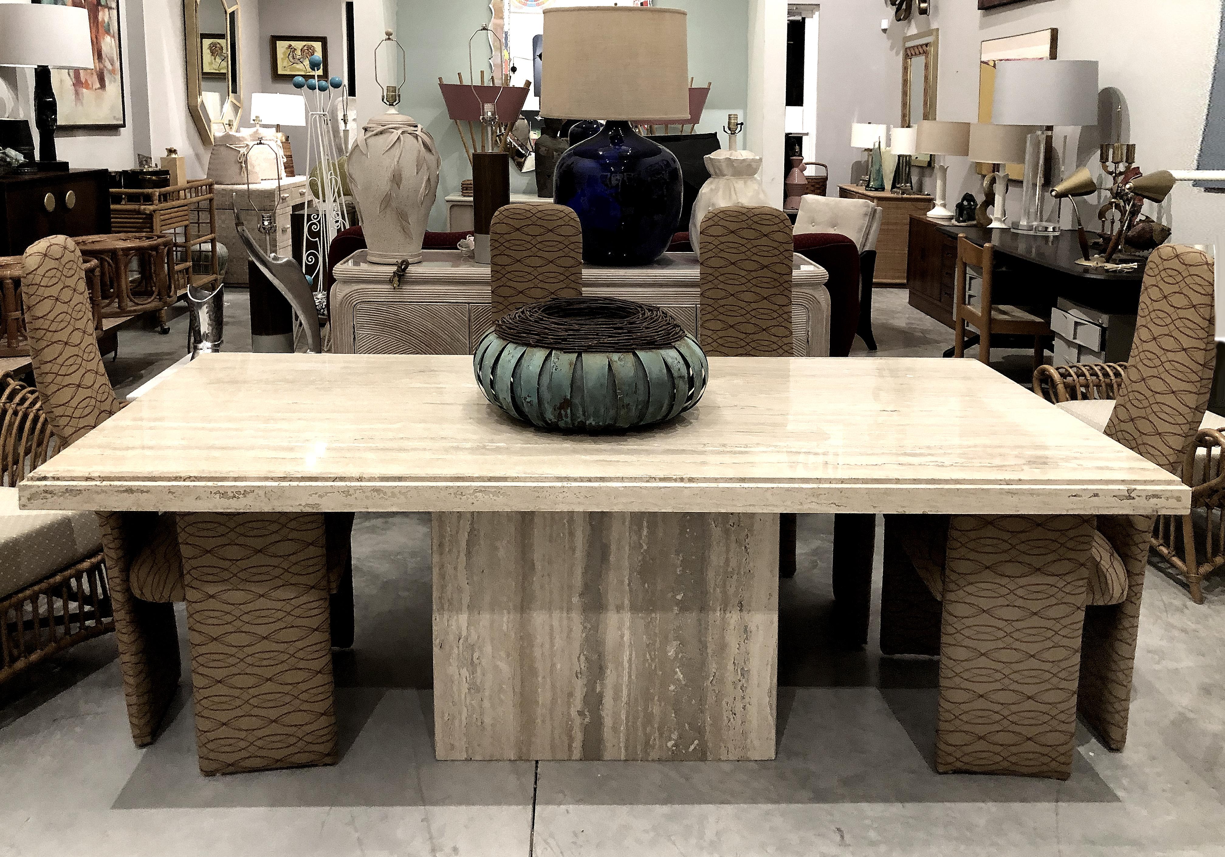 1970s polished Italian travertine stone dining table

Offered for sale is a stunning 1970s Italian select polished travertine dining table on a monolithic pedestal base. The top and base have great linear veining and the apron edge has a step-down