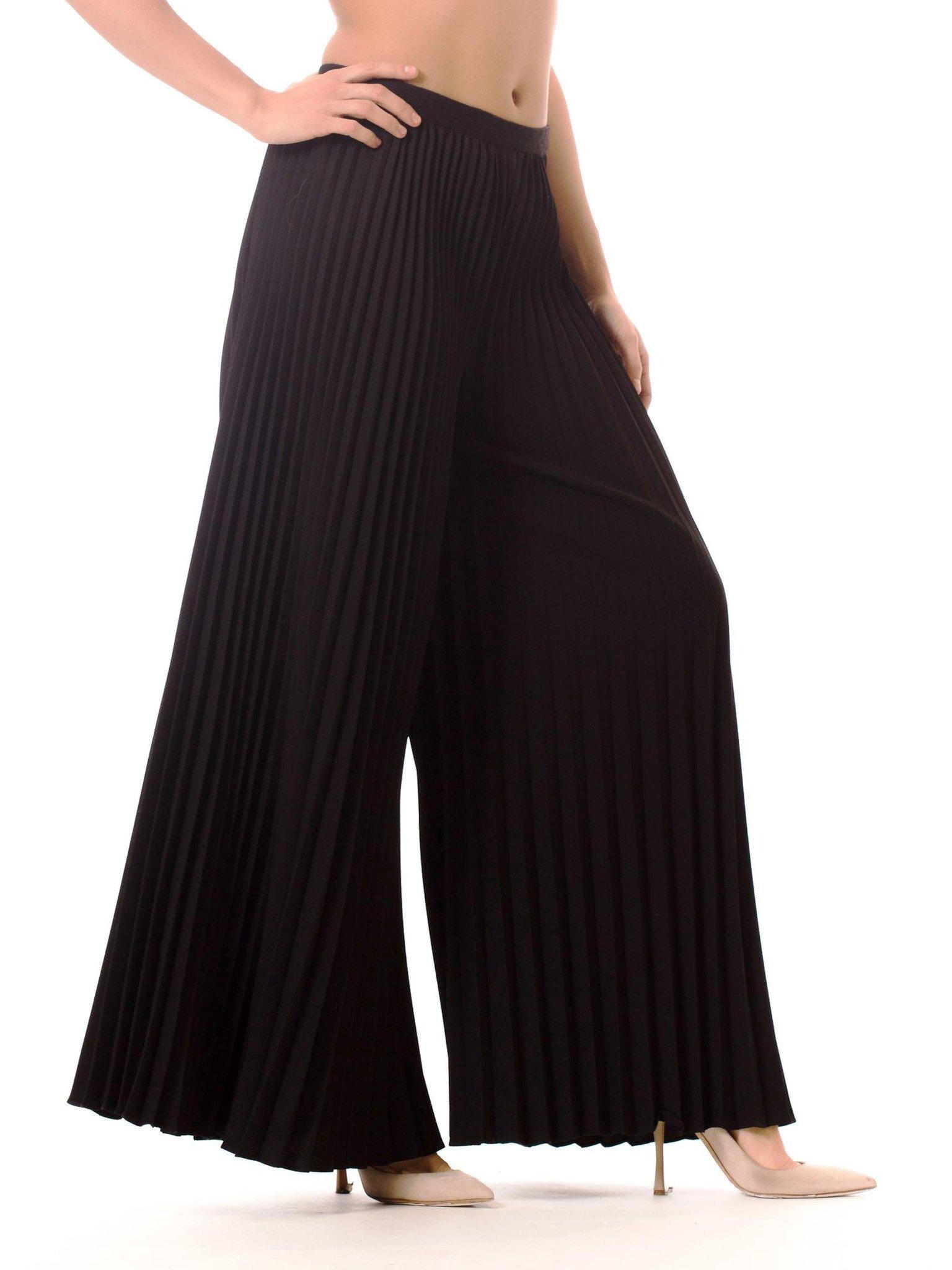 1970S Polyester  Funky And Chic These Black, Wide Leg Pants Feature Tight, Well-Ordered Pleats Down The Entire Length. Rest On Hipline. Design Combined With Long Pleats, Create A Playful Yet Sophisticated Garment. Back Zip Closure.