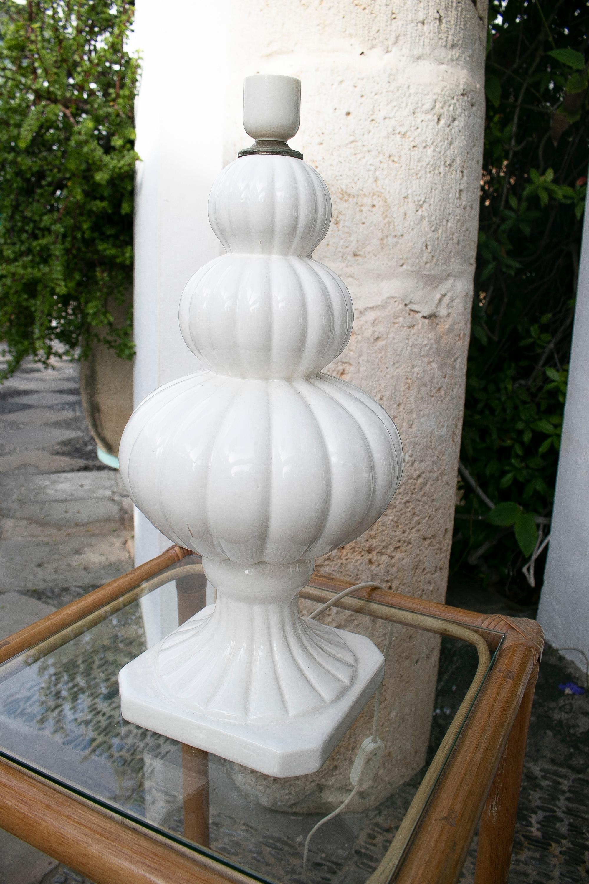 1970's Porcelain table lamp in white colour and with a white rounded shape.
