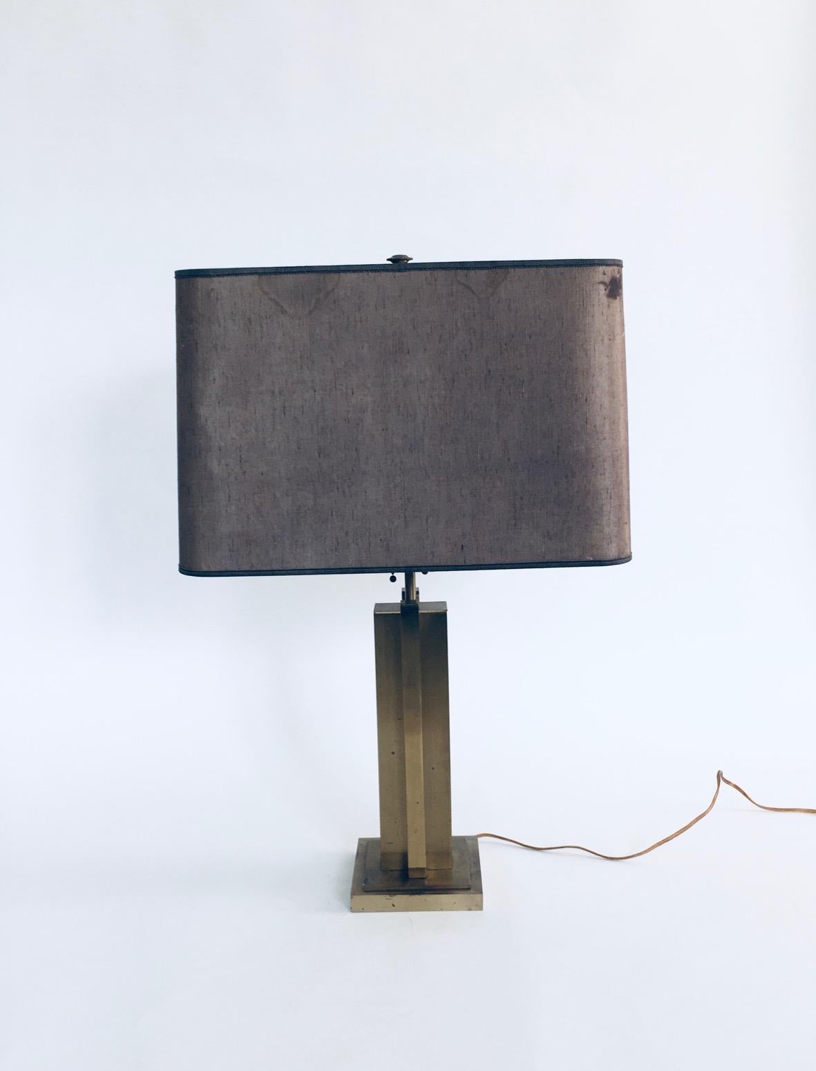 Vintage Postmodern Hollywood Regency Style Design Brass Architectural Table Lamp, made in the 1970's. All brass base with brown lampshade with gold inner finnish. 2 light points in the lamp. Some slight spotting on brass base. The original lampshade