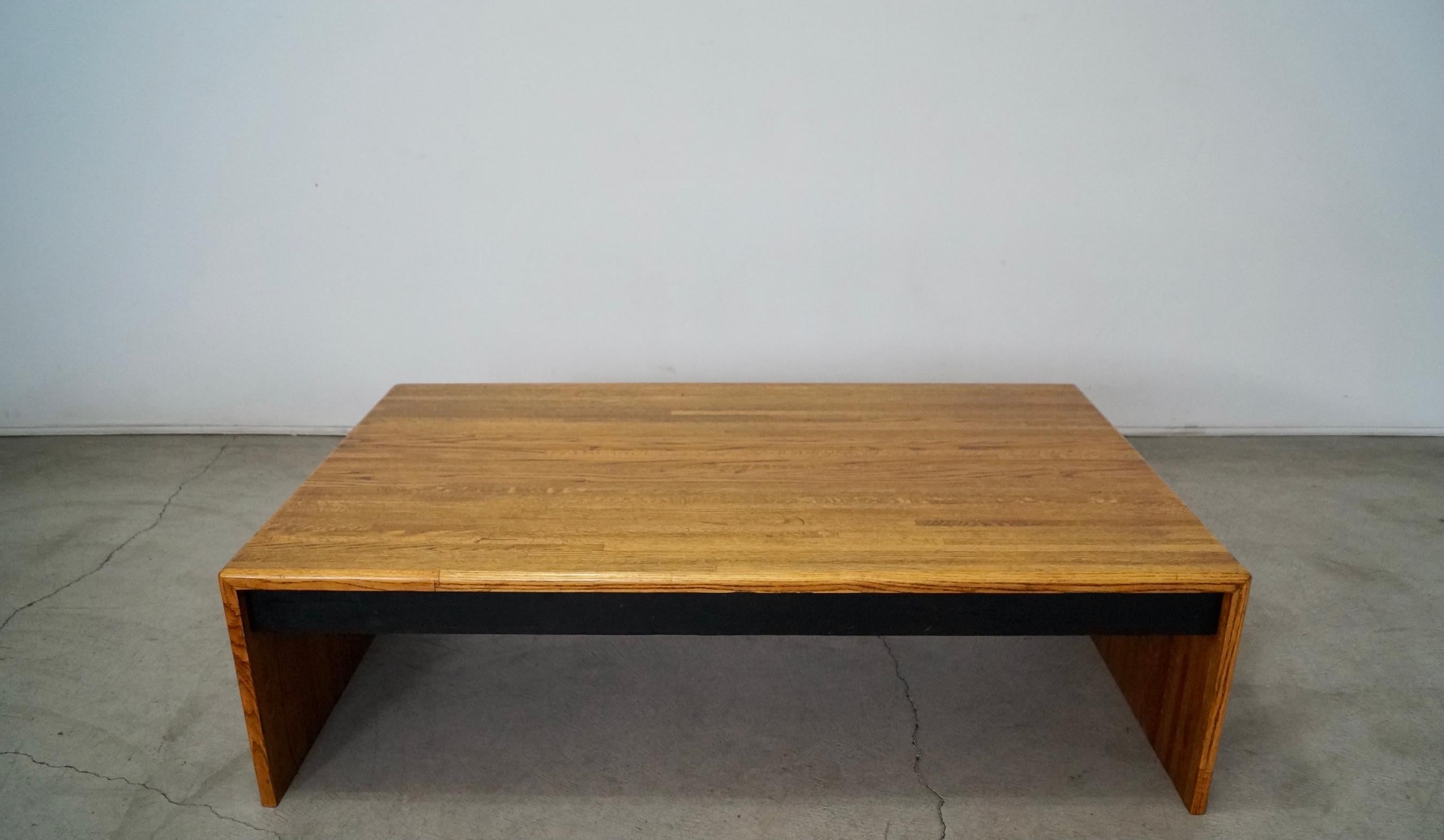 Vintage Mid-century Modern coffee table for sale. From the 1970’s, and in the manner of Lou Hodges designs. Made of solid wood, and has a parquet wood design. It has a clean and modern design with black lacquered wood in the middle. It has a